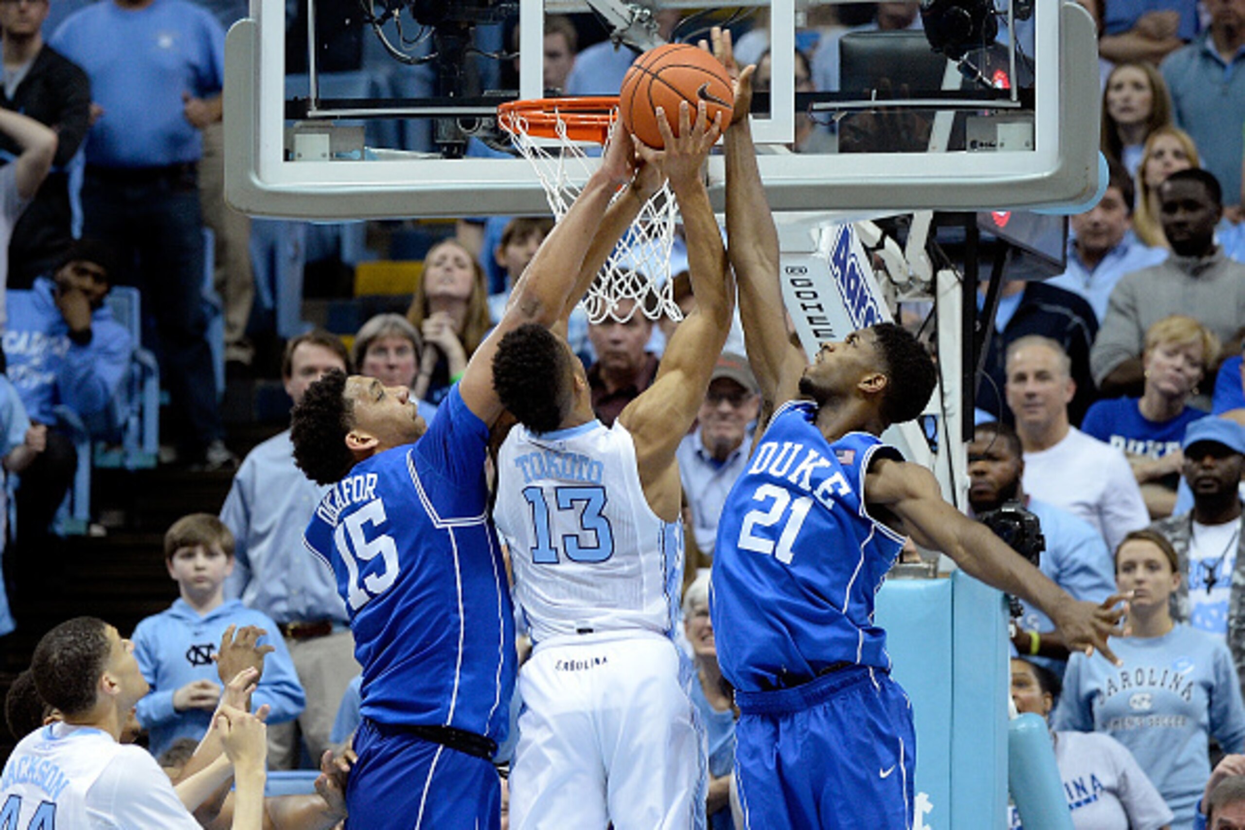 CHAPEL HILL, NC - MARCH 07:  Jahlil Okafor #15 and Amile Jefferson #21 of the Duke Blue Devils block a shot by J.P. Tokoto #13 of the North Carolina Tar Heels during their game at the Dean Smith Center on March 7, 2015 in Chapel Hill, North Carolina.  (Ph