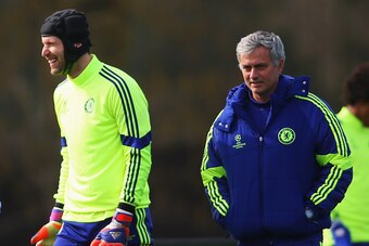 COBHAM, ENGLAND - MARCH 10:  Jose Mourinho manager of Chelsea (R) and goalkeeper Petr Cech (2R) smile during a Chelsea training session ahead of the UEFA Champions League Round of 16 second leg match against Paris Saint-Germain at Chelsea Training Ground 