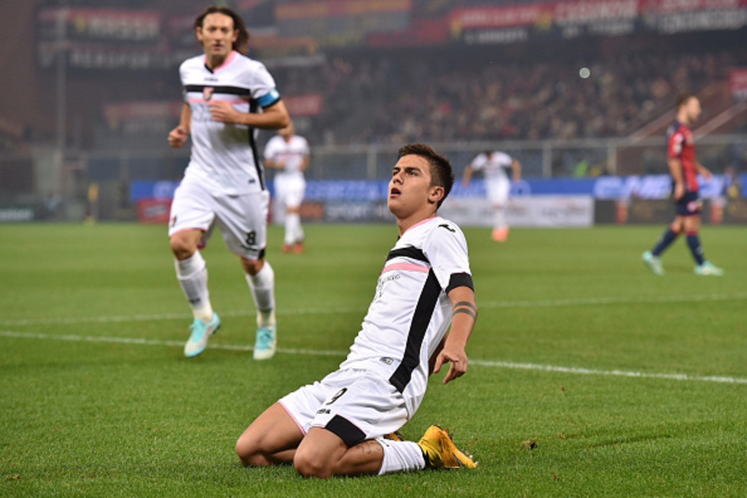 GENOA, ITALY - NOVEMBER 24:  Paulo Dybala (R) of US Citta di Palermo celebrates after scoring the opening goal during the Serie A match between Genoa CFC and US Citta di Palermo at Stadio Luigi Ferraris on November 24, 2014 in Genoa, Italy.  (Photo by Val