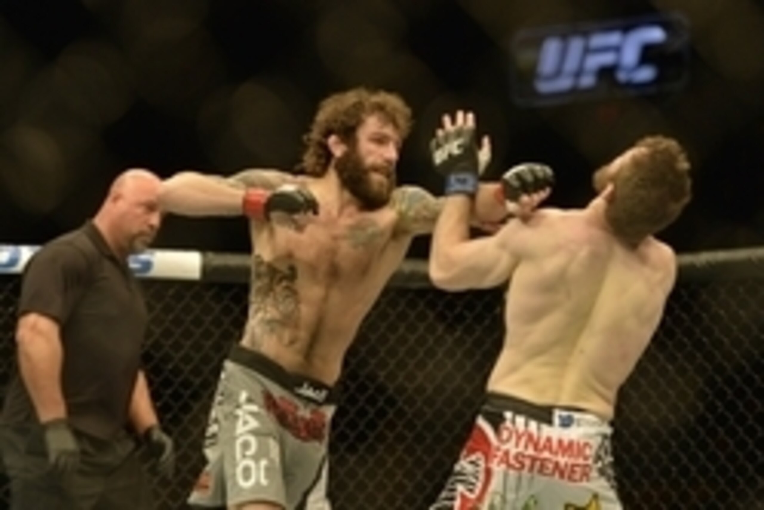 Apr 4, 2015; Fairfax, VA, USA; Michael Chiesa (red gloves) fights Mitch Clarke (blue gloves) during UFC Fight Night at Patriot Center. Mandatory Credit: Tommy Gilligan-USA TODAY Sports
