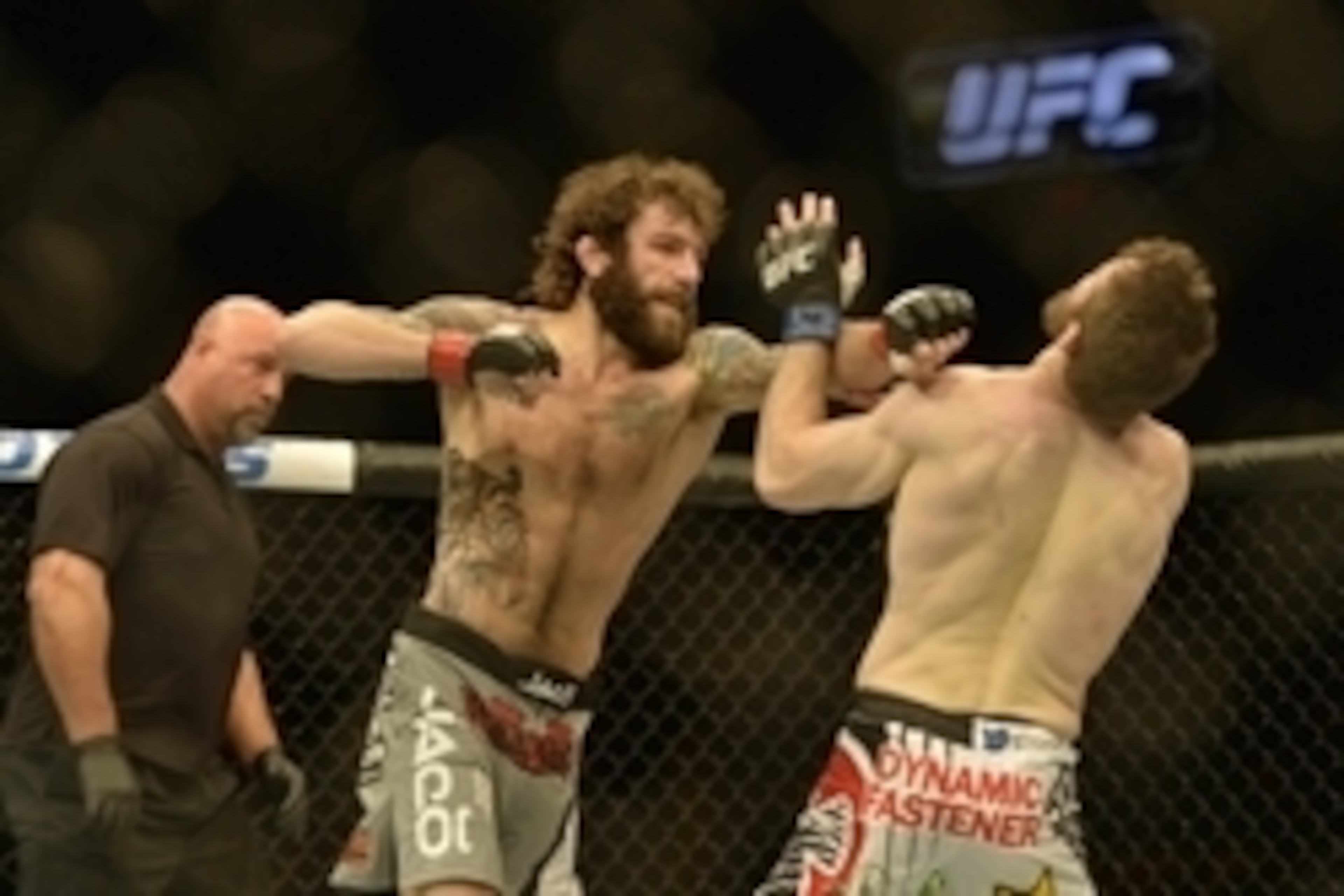 Apr 4, 2015; Fairfax, VA, USA; Michael Chiesa (red gloves) fights Mitch Clarke (blue gloves) during UFC Fight Night at Patriot Center. Mandatory Credit: Tommy Gilligan-USA TODAY Sports