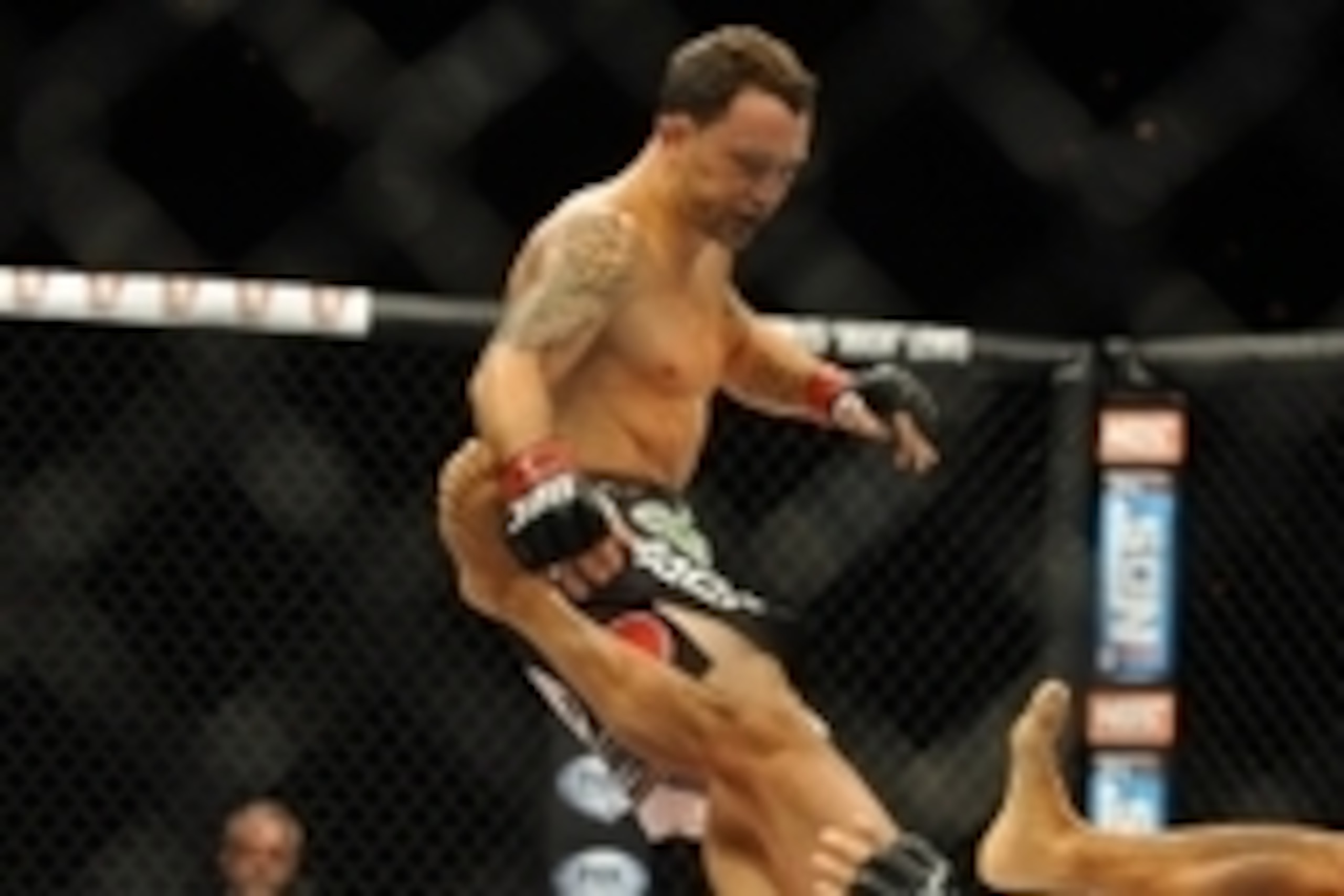 Jul 6, 2014; Las Vegas, NV, USA; Frankie Edgar (red gloves) takes down B.J. Penn (blue gloves) during a featherweight fight at Mandalay Bay Events Center. Mandatory Credit: Stephen R. Sylvanie-USA TODAY Sports