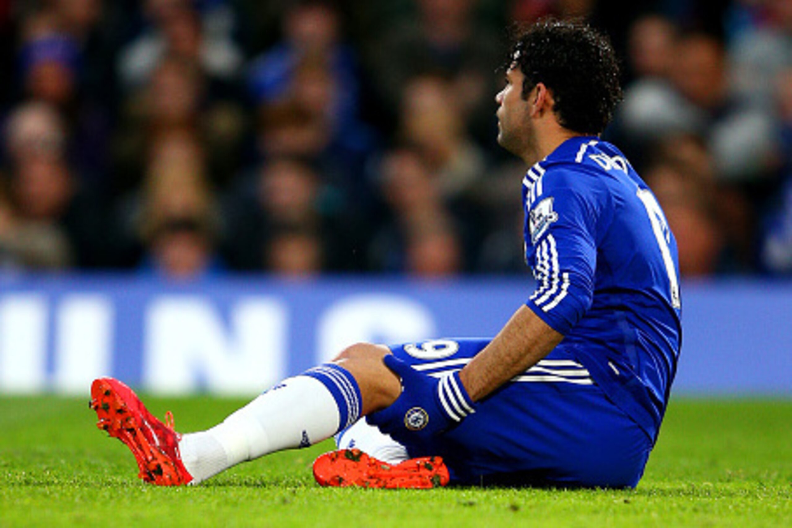LONDON, ENGLAND - APRIL 04:  Diego Costa of Chelsea holds his leg as he sits on the turf before leaving the pitch injured during the Barclays Premier League match between Chelsea and Stoke City at Stamford Bridge on April 4, 2015 in London, England.  (Pho