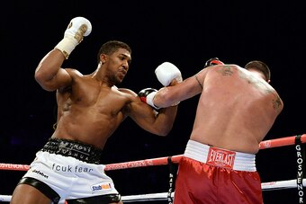 NEWCASTLE UPON TYNE, ENGLAND - APRIL 04:  Anthony Joshua (L) in action with Jason Gavern during their Heavyweight boxing contest at the Metro Arena on April 4, 2015 in Newcastle upon Tyne, England.  (Photo by Nigel Roddis/Getty Images)
