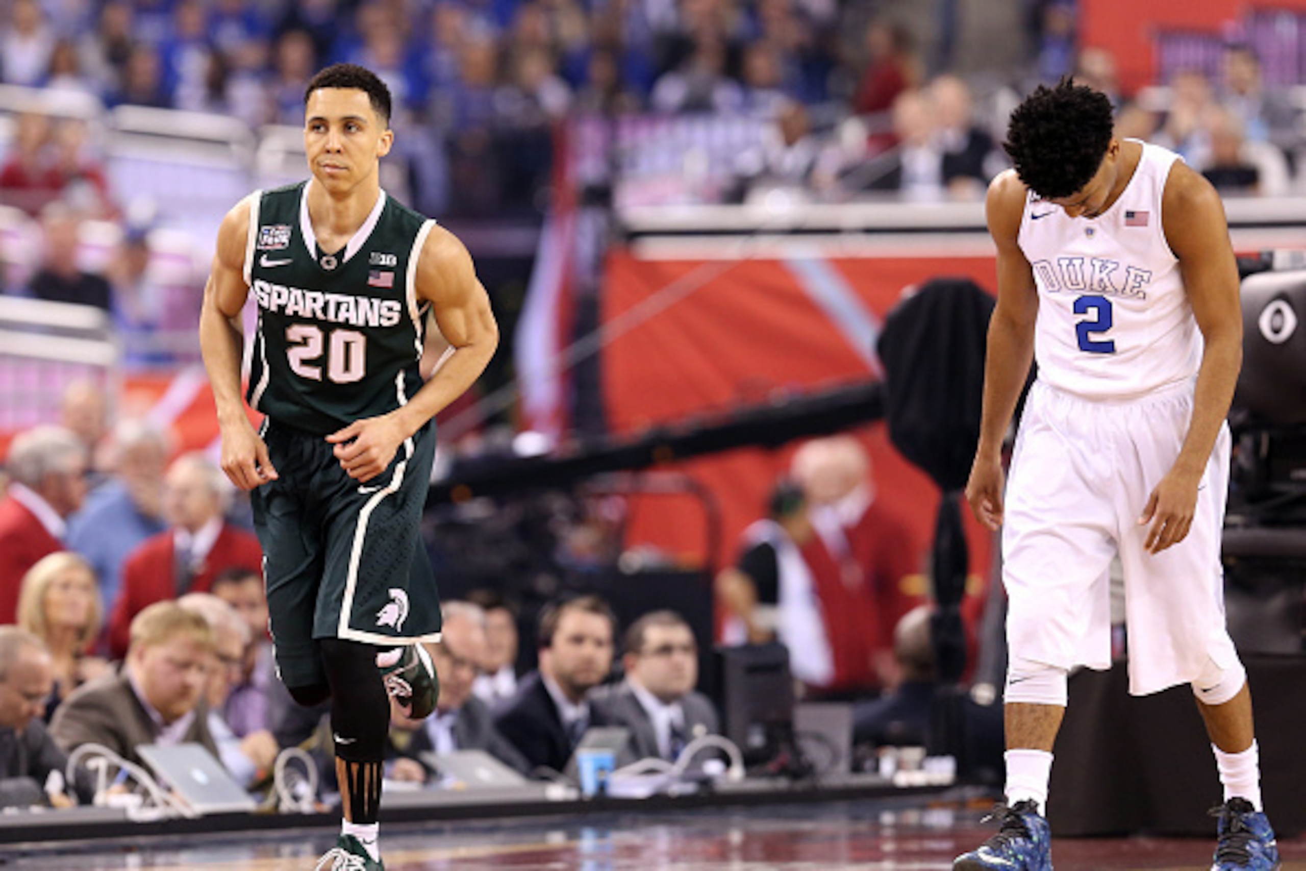 INDIANAPOLIS, IN - APRIL 04: Travis Trice #20 of the Michigan State Spartans reacts after a play in the first half as Quinn Cook #2 of the Duke Blue Devils looks on during the NCAA Men's Final Four Semifinal at Lucas Oil Stadium on April 4, 2015 in Indian
