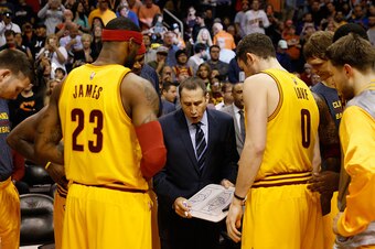 PHOENIX, AZ - JANUARY 13:  Head coach David Blatt of the Cleveland Cavaliers talks with LeBron James #23 and Kevin Love #0 during the NBA game against the Phoenix Suns at US Airways Center on January 13, 2015 in Phoenix, Arizona.  The Suns defeated the Ca