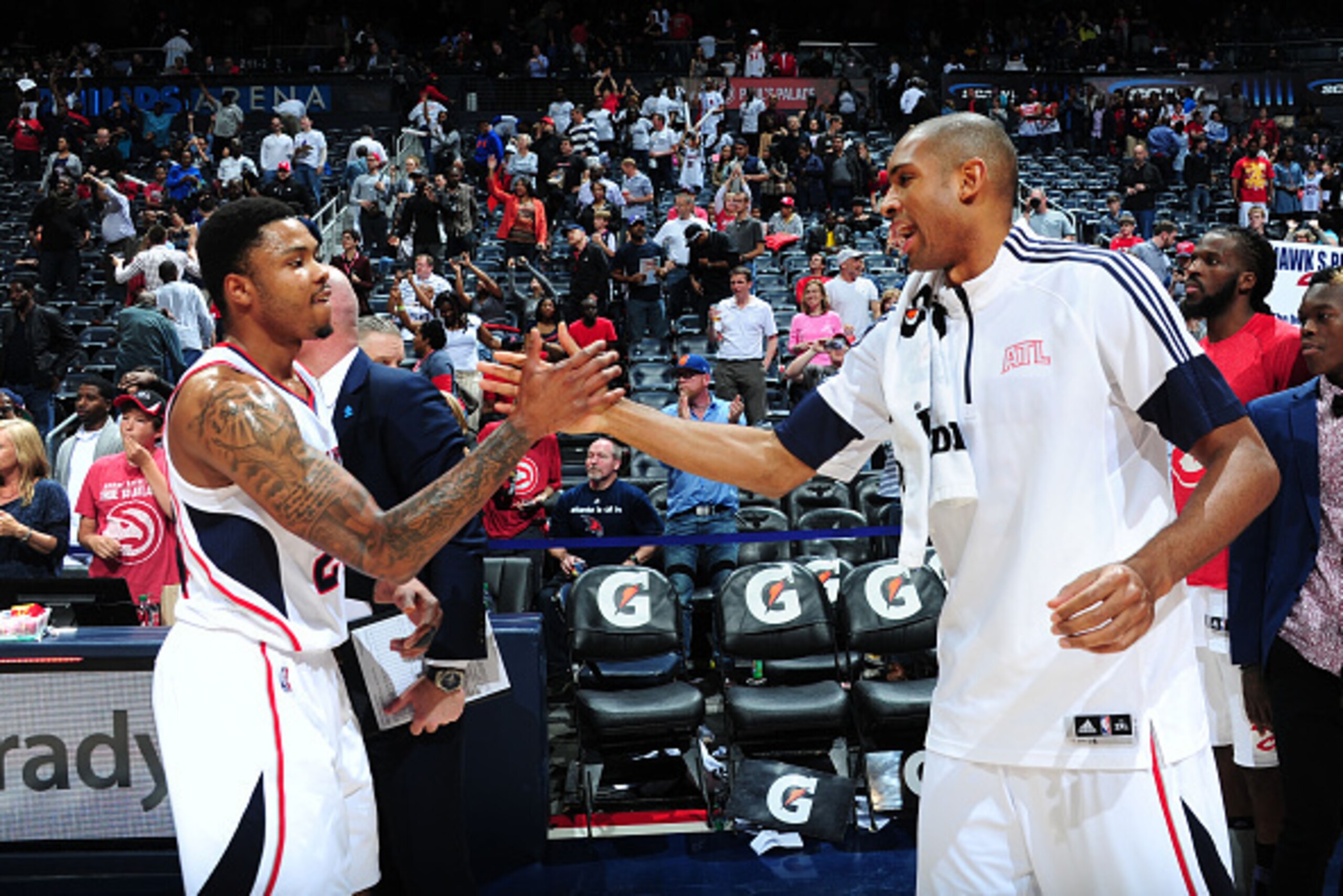 ATLANTA, GA - APRIL 4: Kent Bazemore #24 high fives teammate Al Horford #15 of the Atlanta Hawks after the win against the Brooklyn Nets during the game on April 4, 2015 at Philips Arena in Atlanta, Georgia. NOTE TO USER: User expressly acknowledges and a