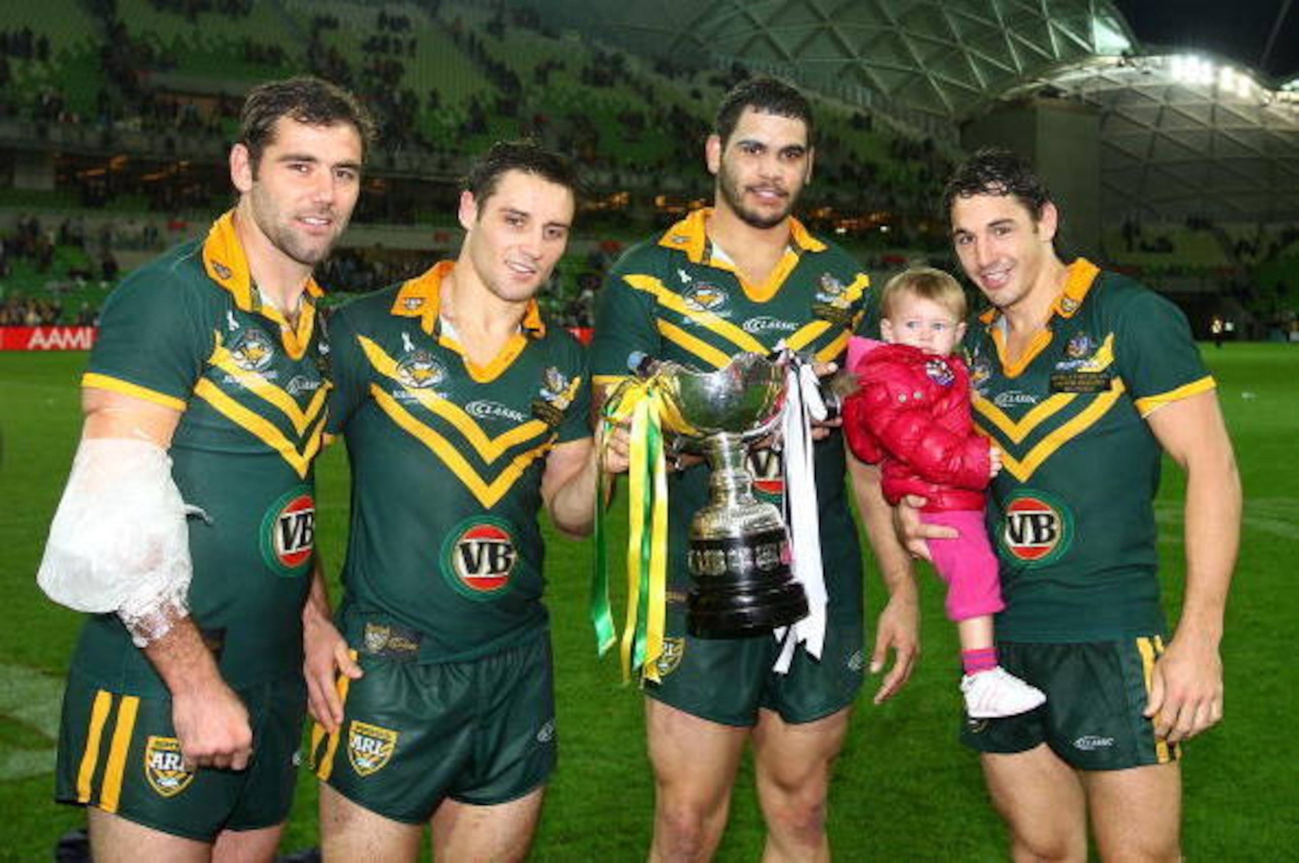 MELBOURNE, AUSTRALIA - MAY 07:  Cameron Smith, Cooper Cronk, Greg Inglis, Billy Slater and his daughter Tyla pose with the trophy after the Kangaroos won the ARL Test match between the Australian Kangaroos and the New Zealand Kiwis at AAMI Park on May 7, 