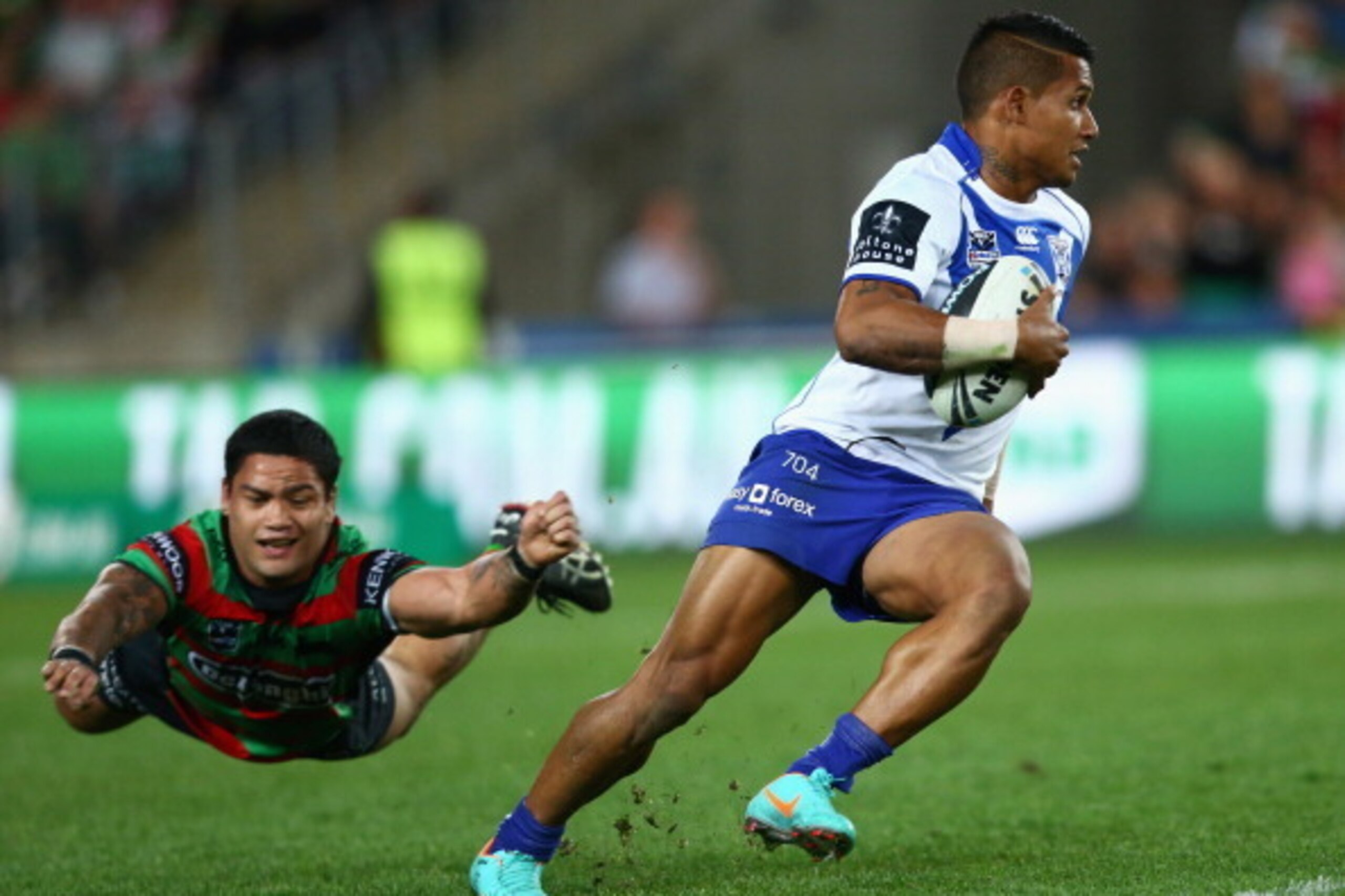 SYDNEY, AUSTRALIA - SEPTEMBER 22:  Ben Barba of the Bulldogs evades the attempted tackle of Issac Luke of the Rabbitohs during the NRL Preliminary Final match between the Canterbury Bulldogs and the South Sydney Rabbitohs at ANZ Stadium on September 22, 2