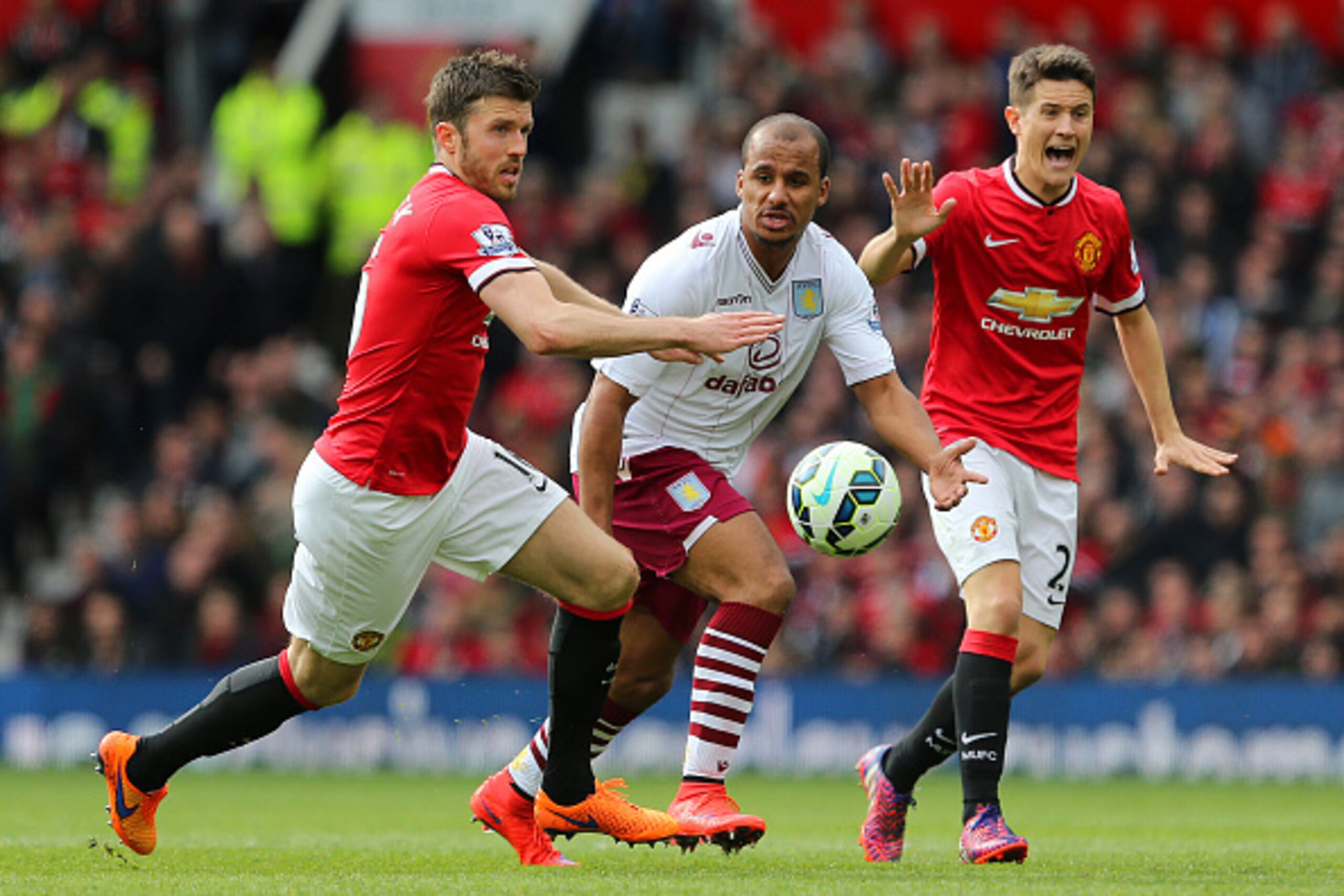 MANCHESTER, ENGLAND - APRIL 04:  Gabriel Agbonlahor of Aston Villa battles for the ball with Michael Carrick of Manchester United and Ander Herrera of Manchester United during the Barclays Premier League match between Manchester United and Aston Villa at 