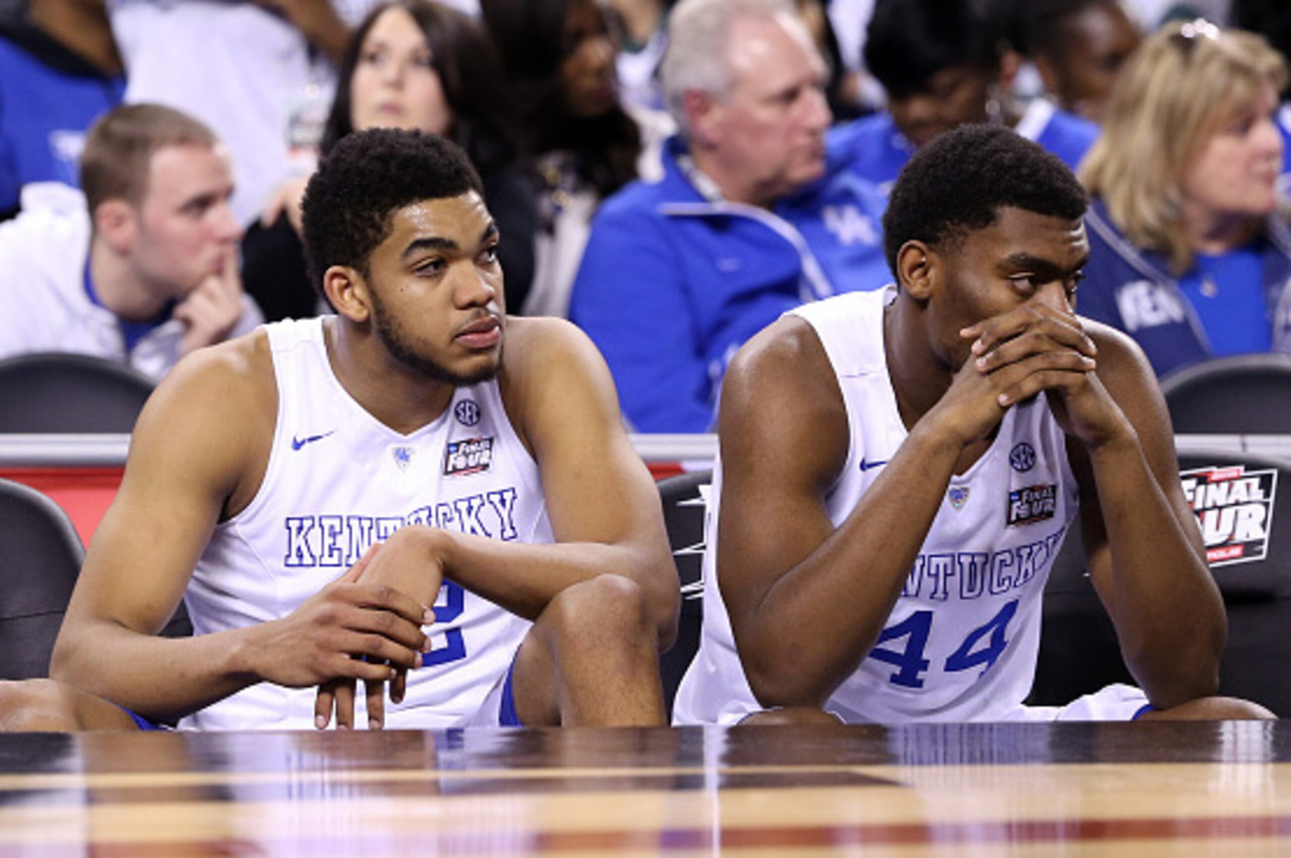 INDIANAPOLIS, IN - APRIL 04: Karl-Anthony Towns #12 and Dakari Johnson #44 of the Kentucky Wildcats look on from the bench late in the game against the Wisconsin Badgers during the NCAA Men's Final Four Semifinal at Lucas Oil Stadium on April 4, 2015 in I