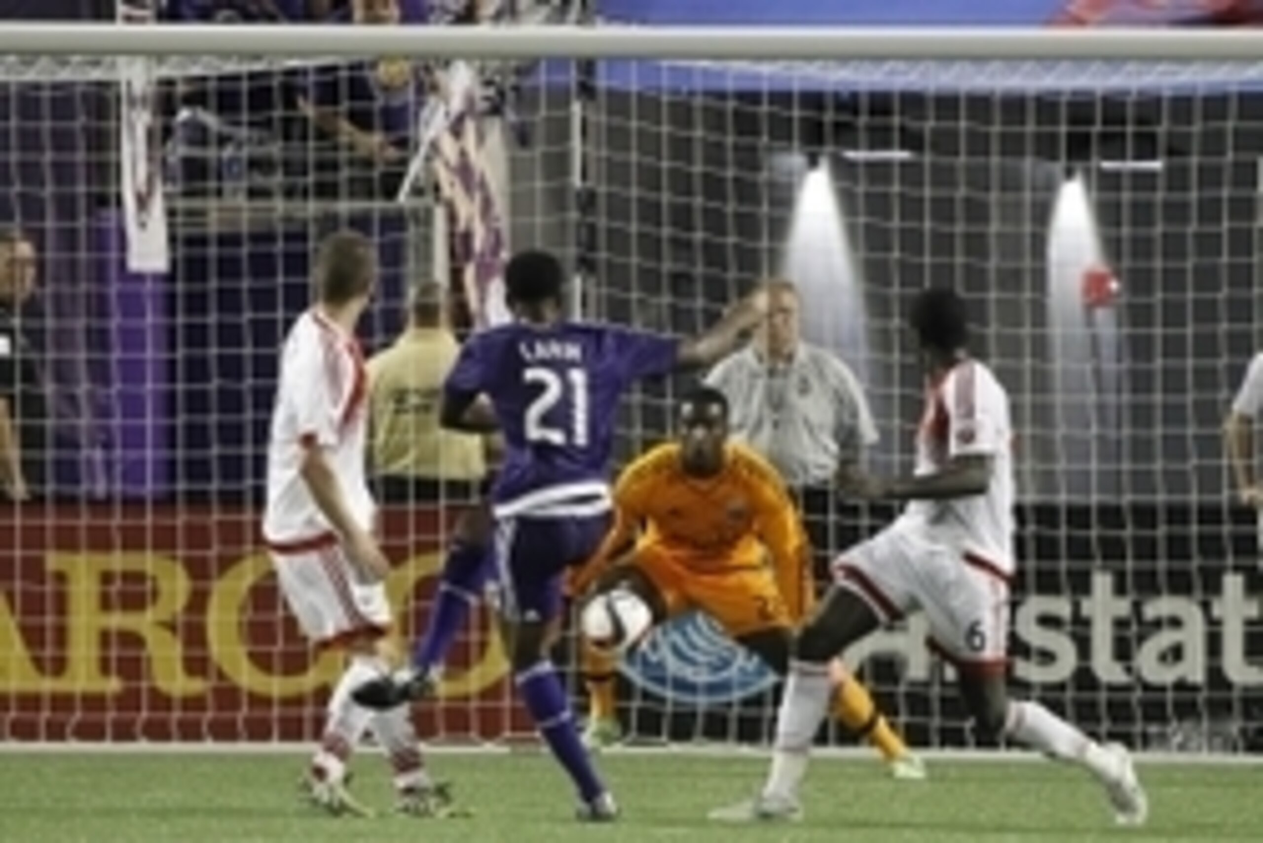 Apr 3, 2015; Orlando, FL, USA; Orlando City SC forward Cyle Larin (21) kicks as D.C. United goalkeeper Bill Hamid (28) defends during the second half at Orlando Citrus Bowl Stadium. D.C. United defeated the Orlando City SC 1-0. Mandatory Credit: Kim Kleme