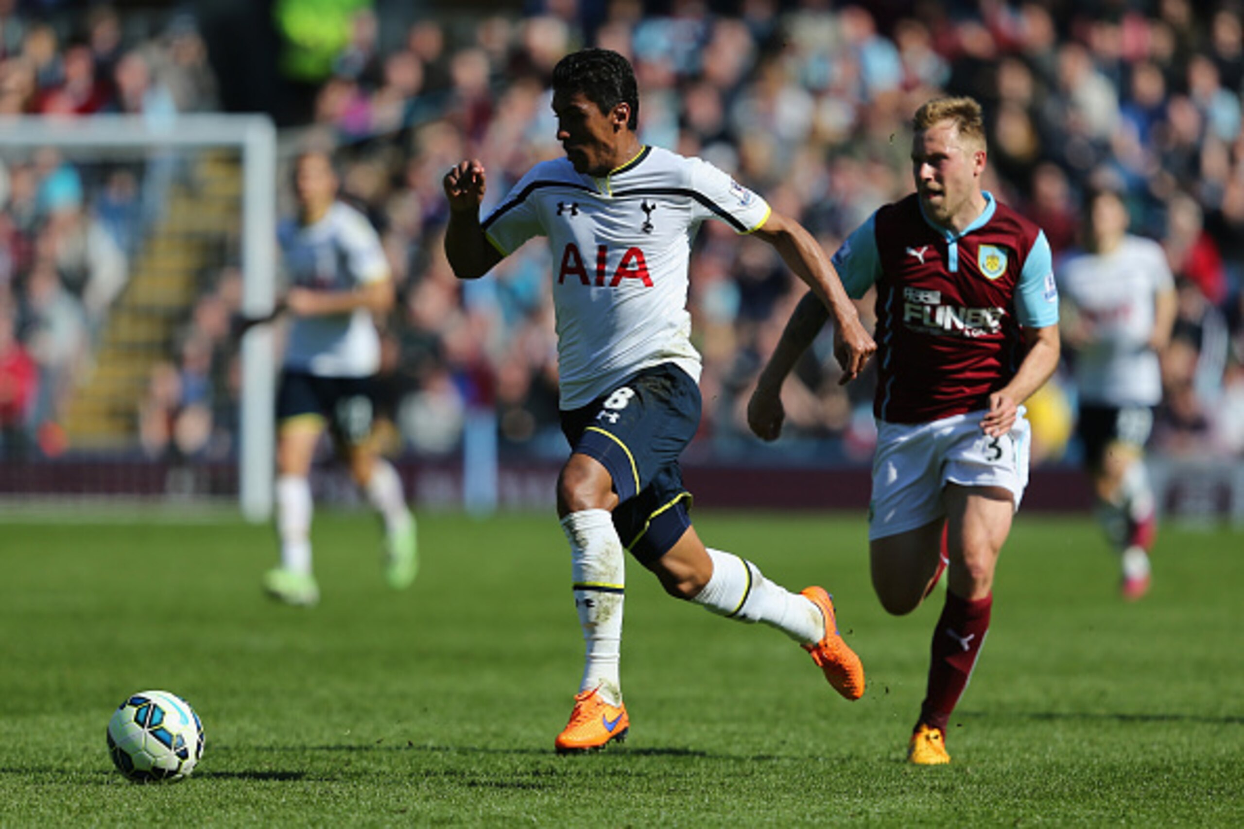 BURNLEY, ENGLAND - APRIL 05:  Paulinho of Spurs breaks clear of Scott Arfield of Burnley during the Barclays Premier League match between Burnley and Tottenham Hotspur at Turf Moor on April 5, 2015 in Burnley, England.  (Photo by Jan Kruger/Getty Images)