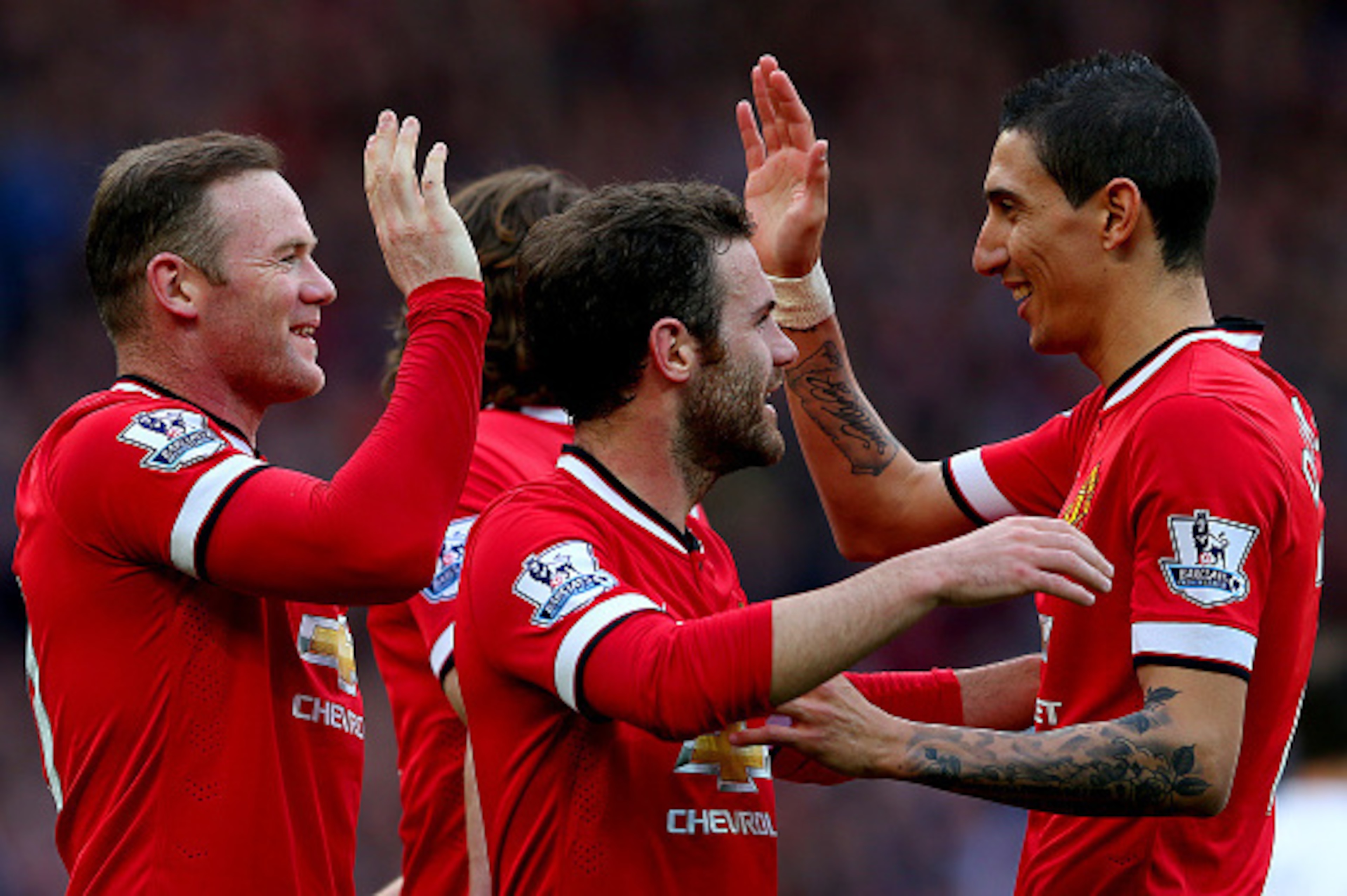 MANCHESTER, ENGLAND - APRIL 04:  Wayne Rooney of Manchester United celebrates with team-mates after scoring his team's second goal during the Barclays Premier League match between Manchester United and Aston Villa at Old Trafford on April 4, 2015 in Manch