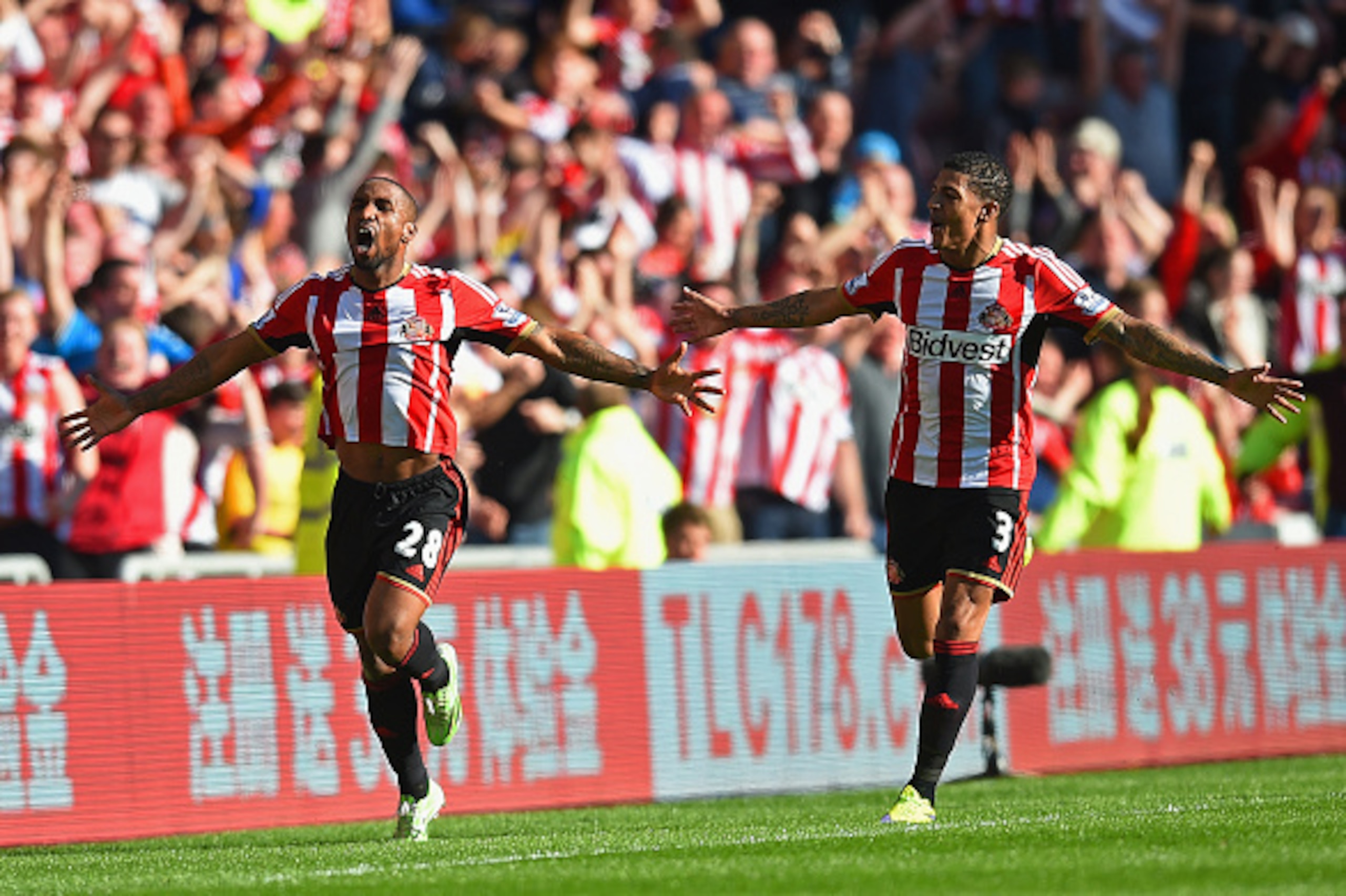 SUNDERLAND, ENGLAND - APRIL 05:  Jermain Defoe of Sunderland (L) celebrates scoring the opening goal with Patrick van Aanholt of Sunderland  during the Barclays Premier League match between Sunderland and Newcastle United at Stadium of Light on April 5, 2