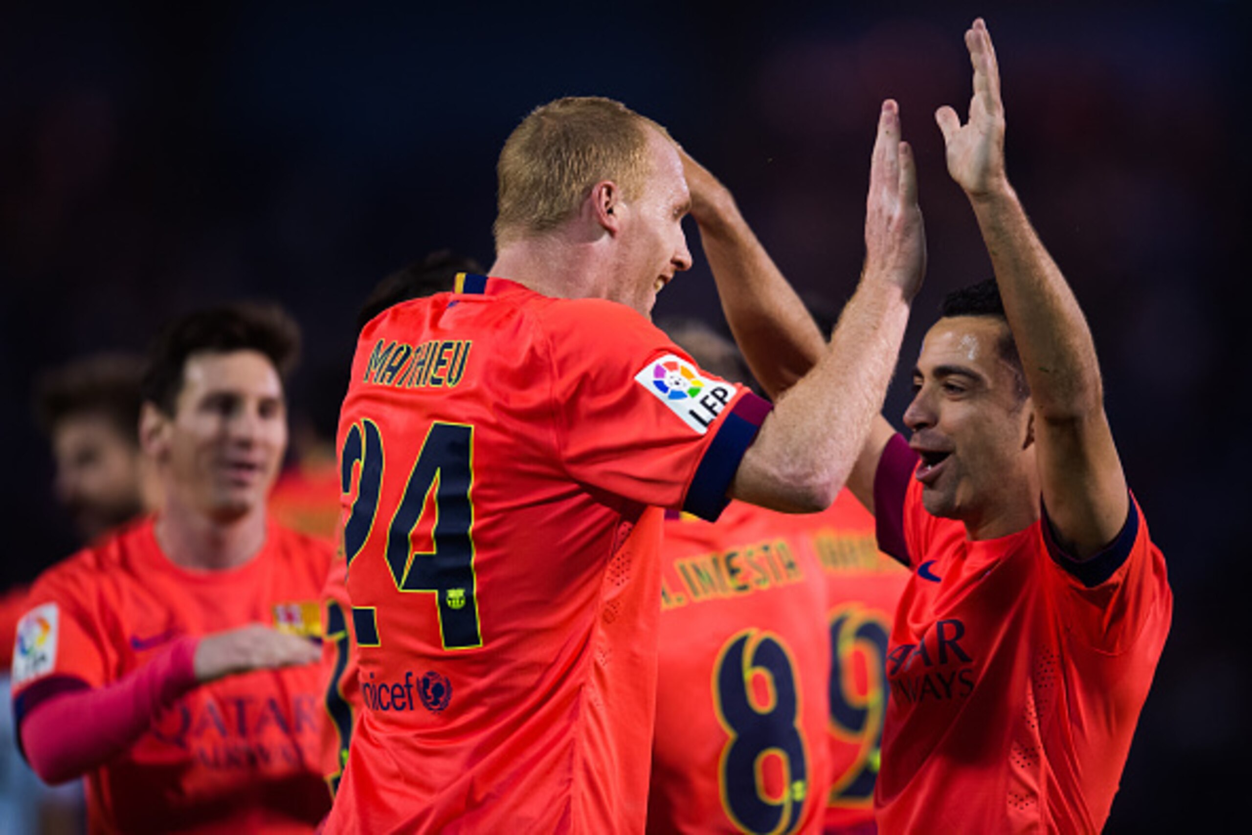 VIGO, SPAIN - APRIL 05: Xavi Hernandez (R) of FC Barcelona congratulates his teammate Jeremy Mathieu after he scored the opening goal during the La Liga match between Celta Vigo and FC Barcelona at Estadio Balaidos on April 5, 2015 in Vigo, Spain. (Photo 