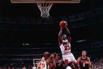 CHICAGO - MAY 22:  Michael Jordan #23 of the Chicago Bulls goes up for a shot against Voshon Lenard #21 of the Miami Heat in Game Two of the Eastern Conference Finals during the 1997 NBA Playoffs at the United Center on May 22, 1997 in Chicago, Illinois. 