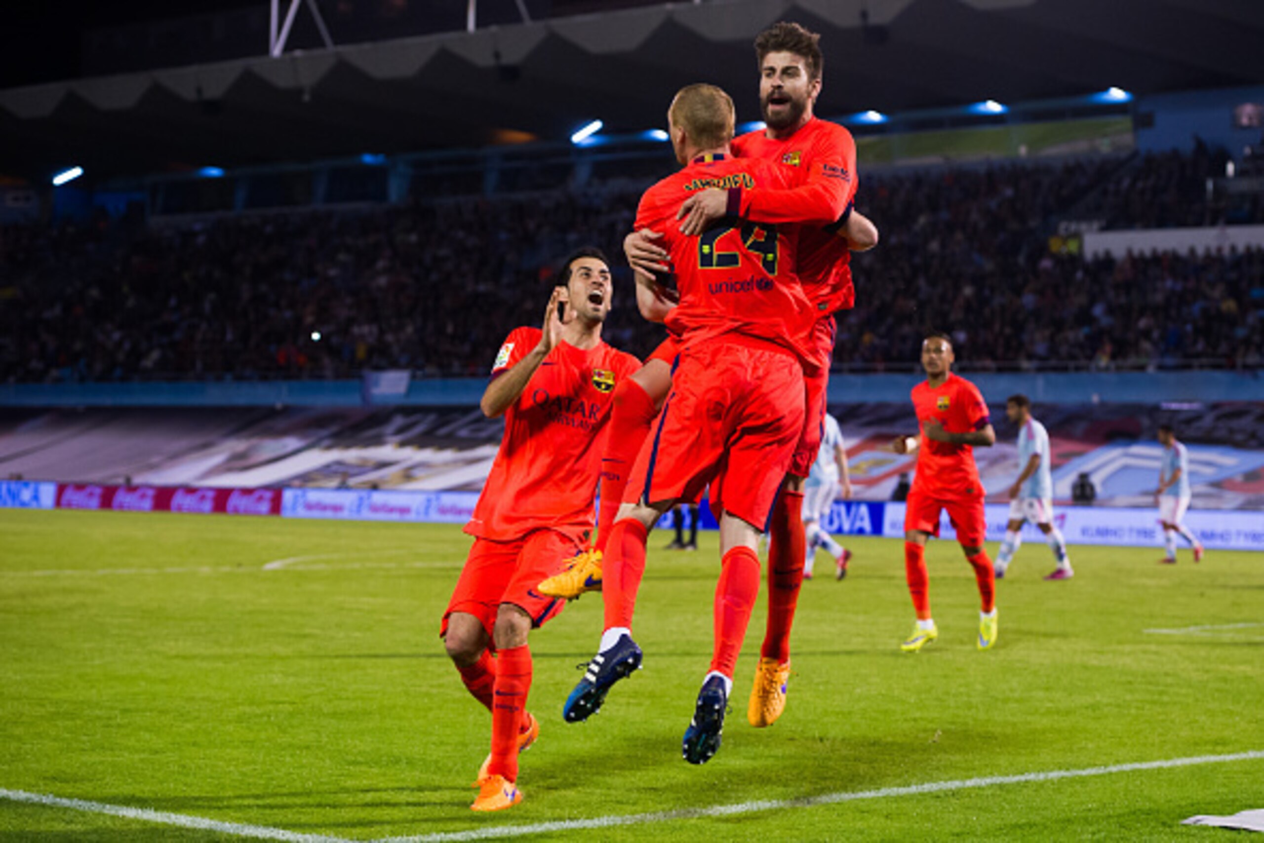 VIGO, SPAIN - APRIL 05: Jeremy Mathieu of FC Barcelona celebrates with his teammates Gerard Pique and Sergio Busquets after scoring the opening goal during the La Liga match between Celta Vigo and FC Barcelona at Estadio Balaidos on April 5, 2015 in Vigo VIGO, SPAIN - APRIL 05: Jeremy Mathieu of FC Barcelona celebrates with his teammates Gerard Pique and Sergio Busquets after scoring the opening goal during the La Liga match between Celta Vigo and FC Barcelona at Estadio Balaidos on April 5, 2015 in Vigo