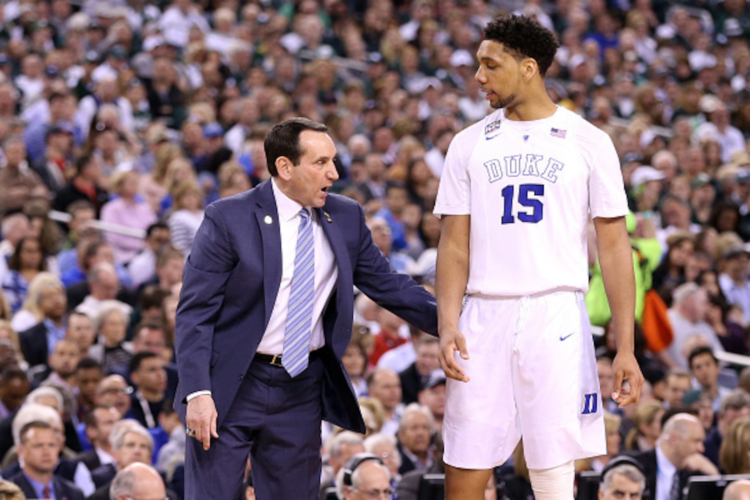 INDIANAPOLIS, IN - APRIL 04: Head coach Mike Krzyzewski of the Duke Blue Devils speaks to Jahlil Okafor #15 in the second half against the Michigan State Spartans during the NCAA Men's Final Four Semifinal at Lucas Oil Stadium on April 4, 2015 in Indianap