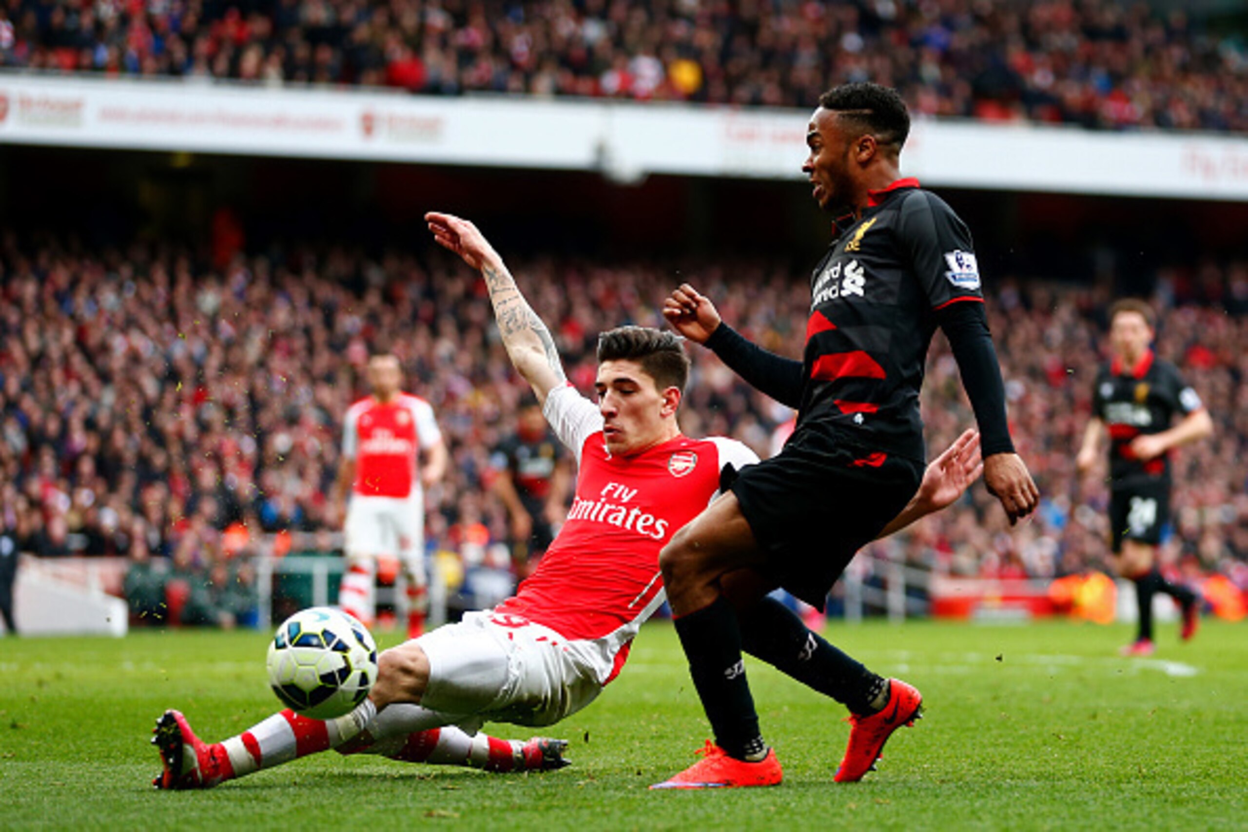 LONDON, ENGLAND - APRIL 04:  Raheem Sterling of Liverpool battles for the ball with Hector Bellerin of Arsenal during the Barclays Premier League match between Arsenal and Liverpool at Emirates Stadium on April 4, 2015 in London, England.  (Photo by Julia