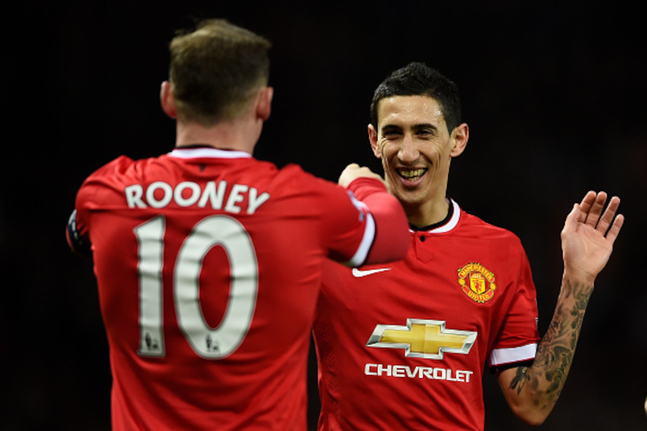 MANCHESTER, ENGLAND - MARCH 09:  Provider of the goal scoring cross Angel di Maria (R) of Manchester United congratultes the scorer Wayne Rooney of Manchester United after the scores are levelled at 1-1 during the FA Cup Quarter Final match between Manche