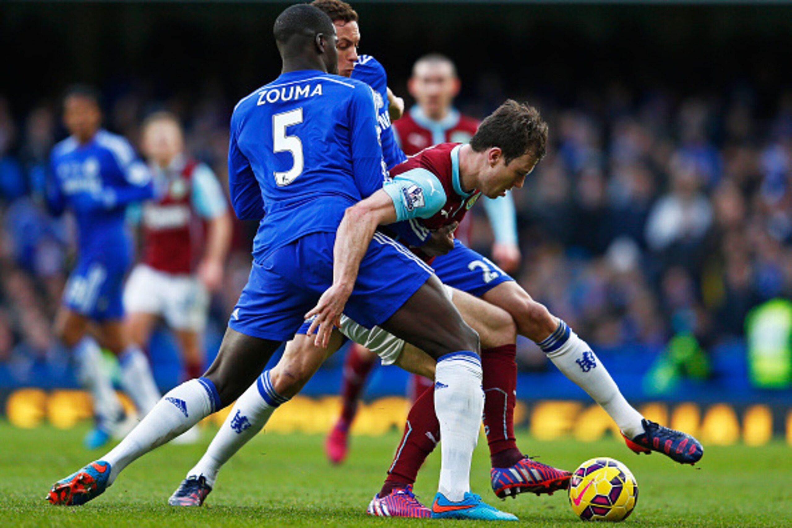 LONDON, ENGLAND - FEBRUARY 21:  Ashley Barnes of Burnley is tackled by Kurt Zouma of Chelsea during the Barclays Premier League match between Chelsea and Burnley at Stamford Bridge on February 21, 2015 in London, England.  (Photo by Julian Finney/Getty Im
