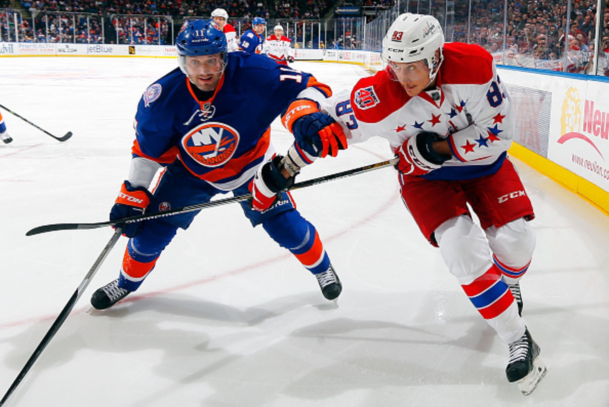 UNIONDALE, NY - DECEMBER 29: Jay Beagle #83 of the Washington Capitals in action against Lubomir Visnovsky #11 of the New York Islanders on December 29, 2014 at Nassau Veterans Memorial Coliseum in Uniondale, New York. The Islanders defeat the Capitals 4-