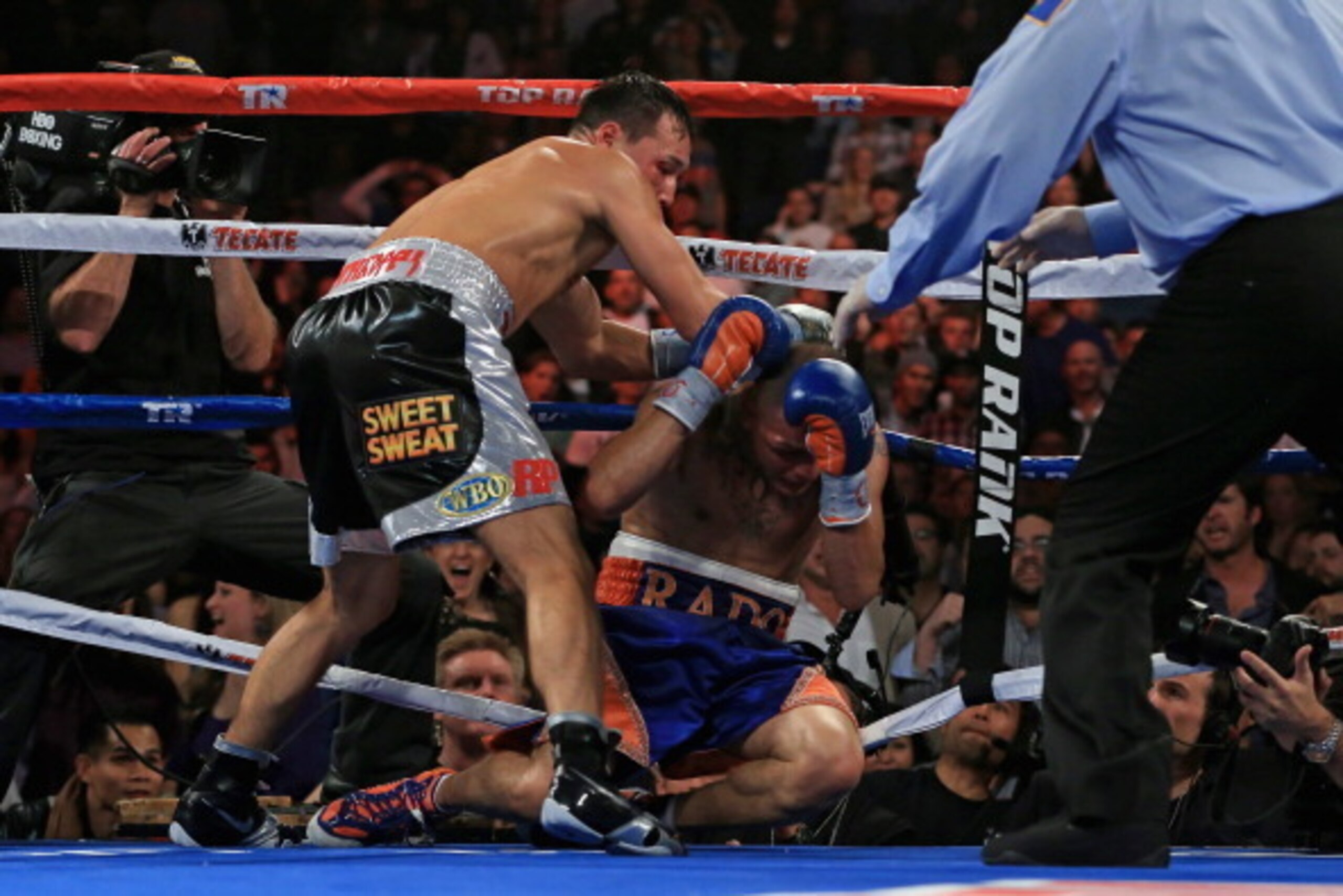 BROOMFIELD, CO - OCTOBER 19:  Ruslan Provodnikov (L) of Russia knocks down Mike Alvarado (R) on the ropes in the eighth round at the 1stBank Center on October 19, 2013 in Broomfield, Colorado. Provodnikov won the bout and claimed the WBO Junior Welterweig