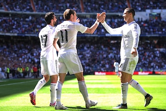 MADRID, SPAIN - APRIL 05:  Gareth Bale of Real Madrid CF celebrates with Cristiano Ronaldo after scoring his team's opening goal during the La Liga match between Real Madrid CF and Granada CF at Estadio Santiago Bernabeu on April 5, 2015 in Madrid, Spain.