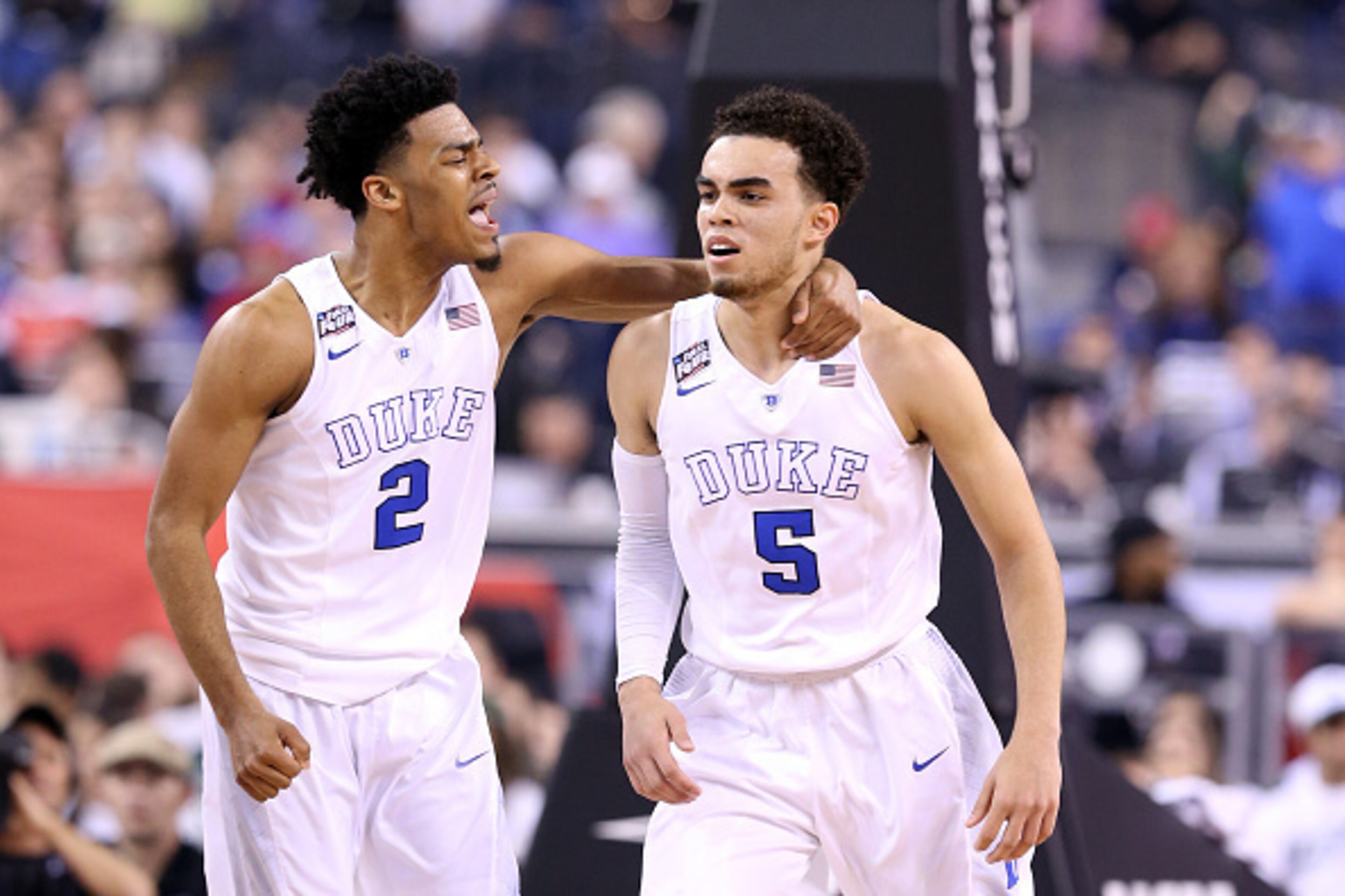 INDIANAPOLIS, IN - APRIL 04:  Quinn Cook #2 and Tyus Jones #5 of the Duke Blue Devils celebrate after a play in the first half against the Michigan State Spartans during the NCAA Men's Final Four Semifinal at Lucas Oil Stadium on April 4, 2015 in Indianap
