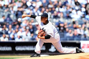 NEW YORK, NY - APRIL 06:  Masahiro Tanaka #19 of the New York Yankees delivers a pitch in the first inning against the Toronto Blue Jays during Opening Day on April 6, 2015 at Yankee Stadium in the Bronx borough of New York City.  (Photo by Elsa/Getty Ima
