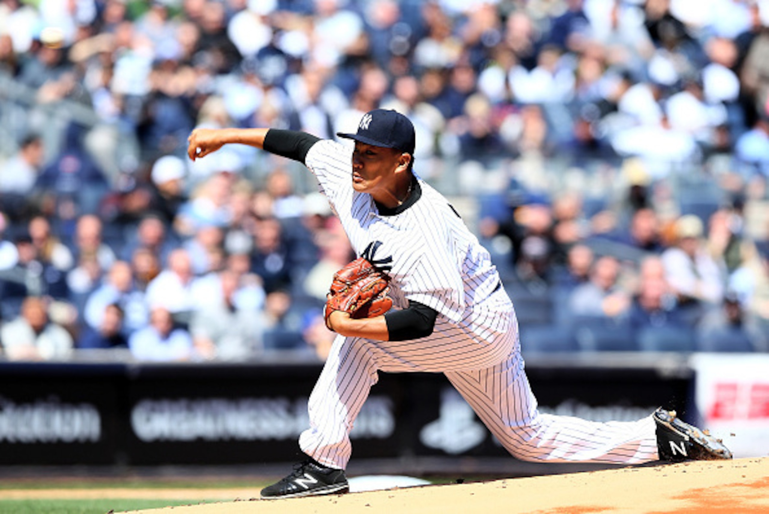 NEW YORK, NY - APRIL 06:  Masahiro Tanaka #19 of the New York Yankees delivers a pitch in the first inning against the Toronto Blue Jays during Opening Day on April 6, 2015 at Yankee Stadium in the Bronx borough of New York City.  (Photo by Elsa/Getty Ima
