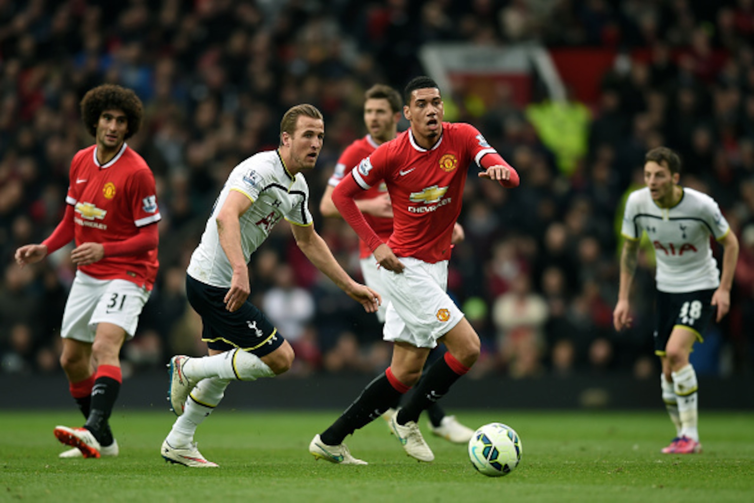 MANCHESTER, ENGLAND - MARCH 15:  Chris Smalling of Manchester United is closed down by Harry Kane of Spurs during the Barclays Premier League match between Manchester United and Tottenham Hotspur at Old Trafford on March 15, 2015 in Manchester, England.  