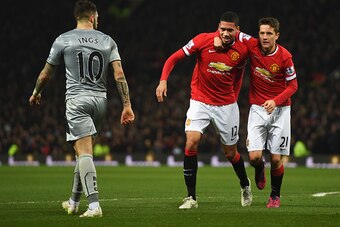 MANCHESTER, ENGLAND - FEBRUARY 11:  Chris Smalling of Manchester United celebrates scoring his second goal with Ander Herrera of Manchester United during the Barclays Premier League match between Manchester United and Burnley at Old Trafford on February 1