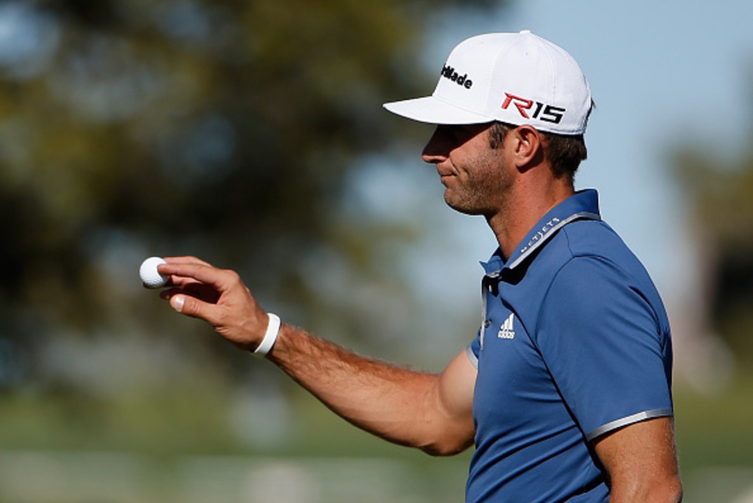 SAN ANTONIO, TX - MARCH 27:  Dustin Johnson reacts after his putt on the 18th hole during round two of the Valero Texas Open at TPC San Antonio AT&T Oaks Course on March 27, 2015 in San Antonio, Texas.  (Photo by Christian Petersen/Getty Images)