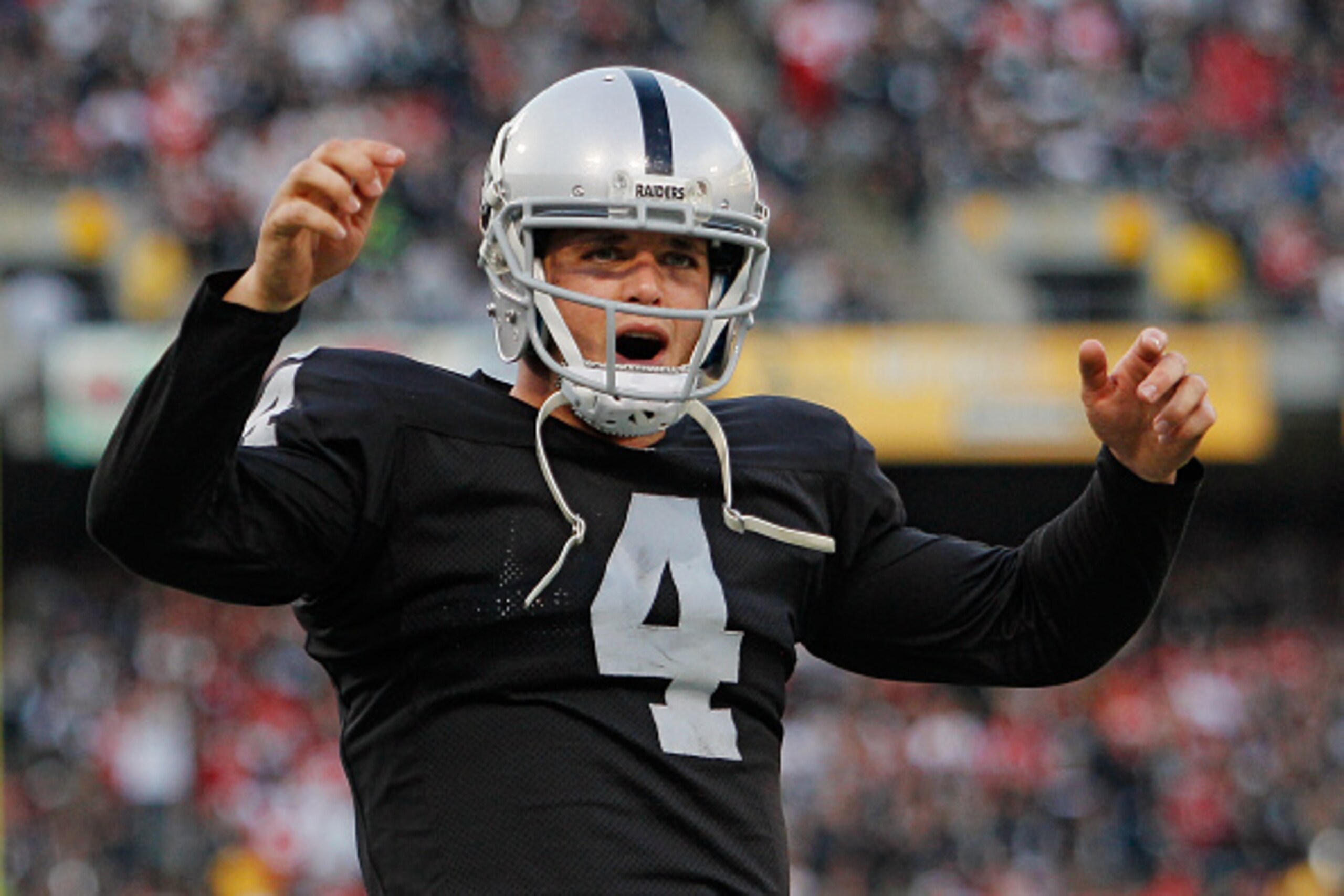 OAKLAND, CA - DECEMBER 7:  Quarterback Derek Carr #4 of the Oakland Raiders celebrates a win against the San Francisco 49ers late in the fourth quarter on December 7, 2014 at O.co Coliseum in Oakland, California.  The Raiders won 24-13.  (Photo by Brian B