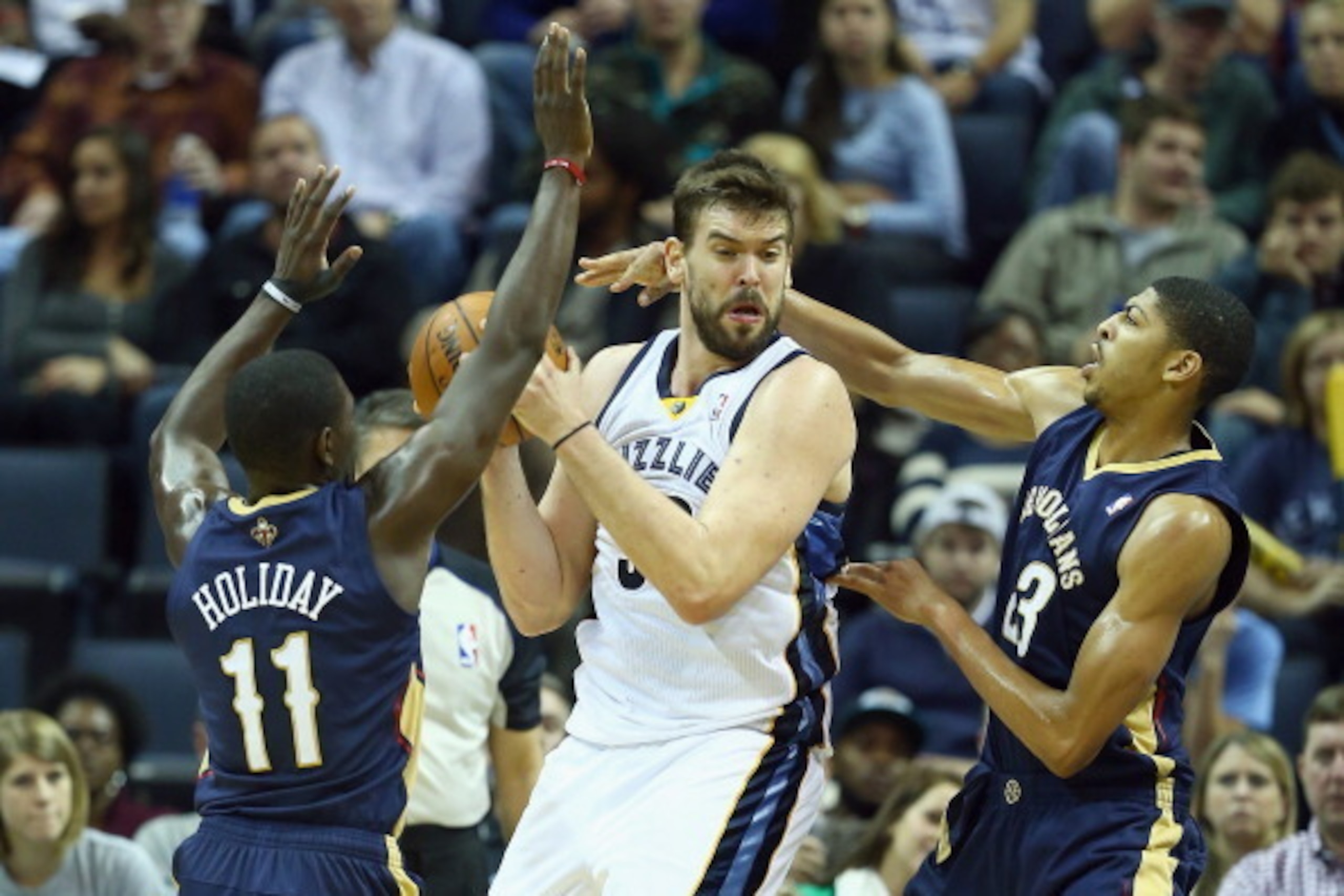 MEMPHIS, TN - NOVEMBER 06: Marc Gasol #33 of the Memphis Grizzlies looks to pass the ball while defended by Jrue Holiday #11 and Anthony Davis #23 of the New Orleans Pelicans during the NBA game at FedExForum on November 6, 2013 in Memphis, Tennessee. N MEMPHIS, TN - NOVEMBER 06: Marc Gasol #33 of the Memphis Grizzlies looks to pass the ball while defended by Jrue Holiday #11 and Anthony Davis #23 of the New Orleans Pelicans during the NBA game at FedExForum on November 6, 2013 in Memphis, Tennessee. N