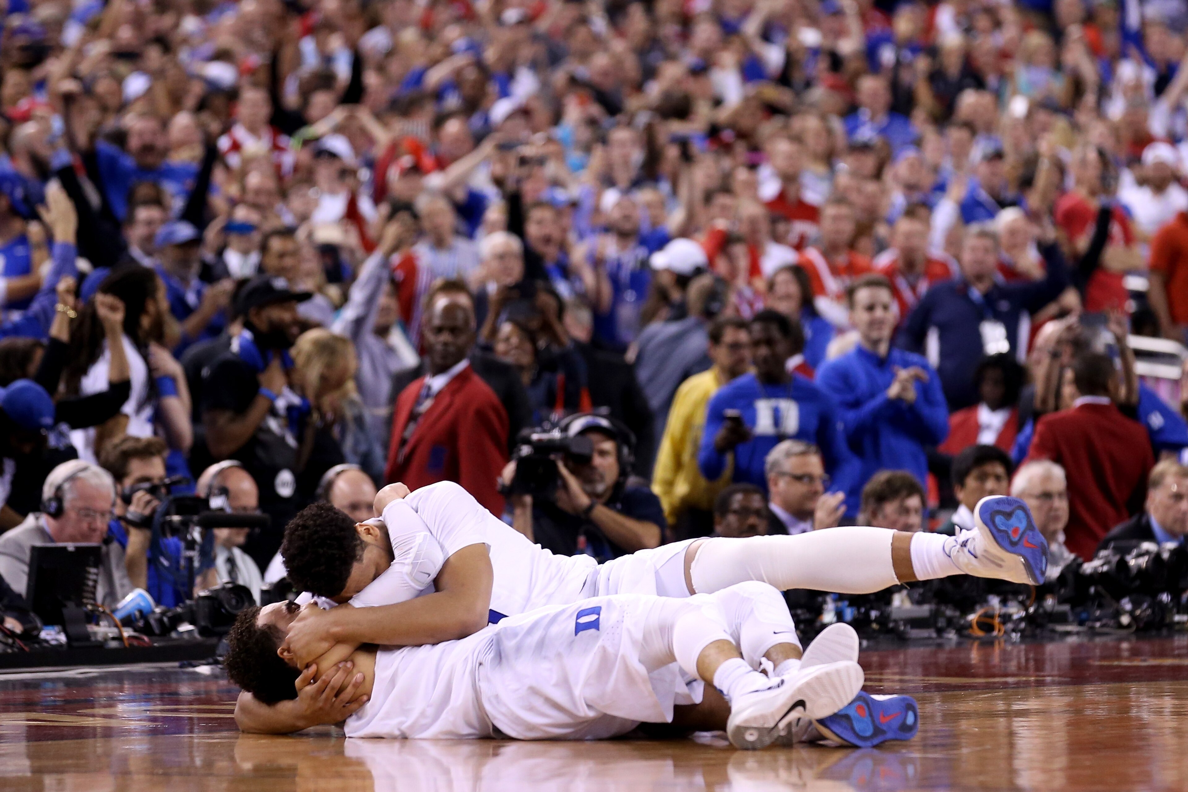 INDIANAPOLIS, IN - APRIL 06:  Jahlil Okafor #15 and Tyus Jones #5 of the Duke Blue Devils celebrate after defeating the Wisconsin Badgers during the NCAA Men's Final Four National Championship at Lucas Oil Stadium on April 6, 2015 in Indianapolis, Indiana