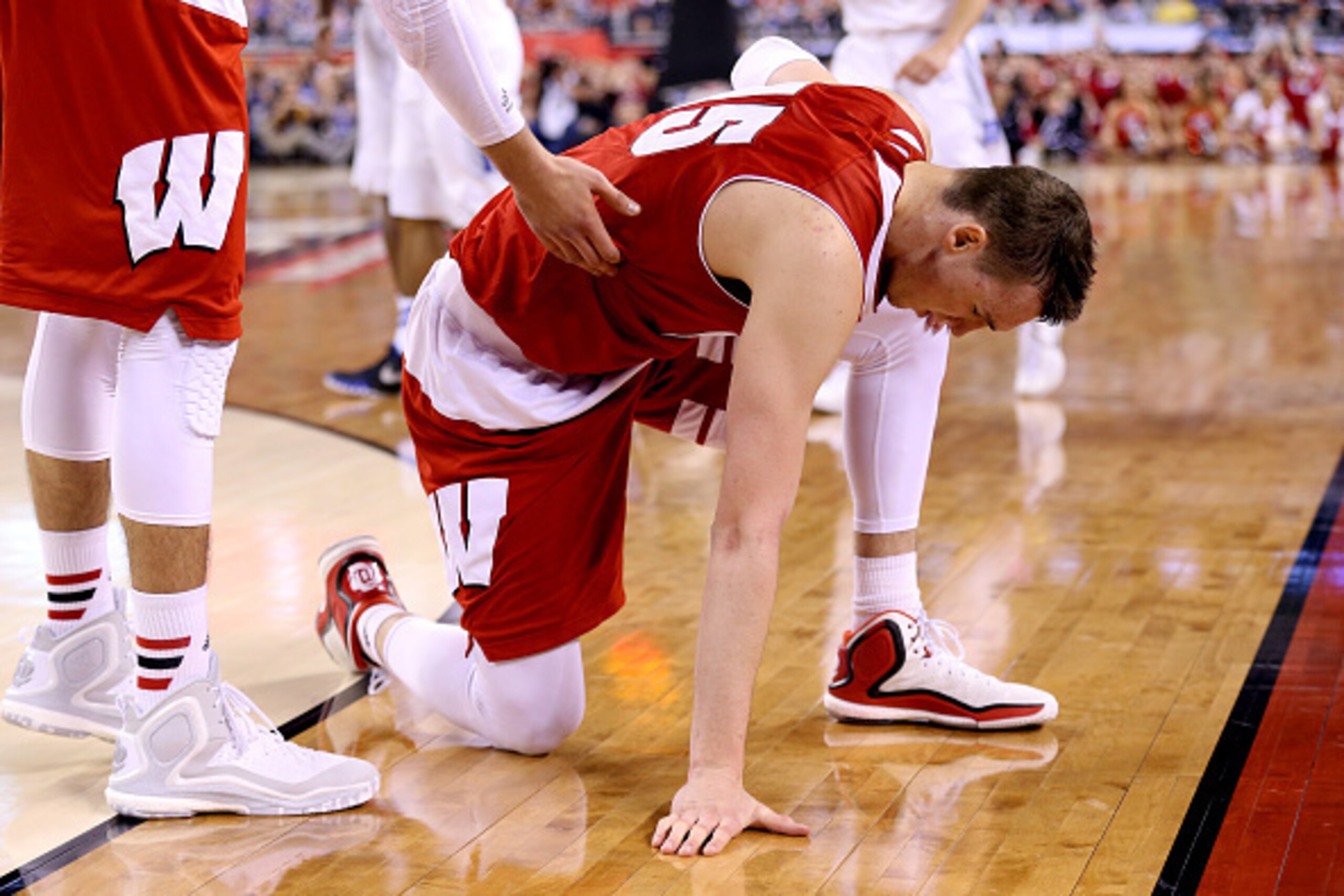 INDIANAPOLIS, IN - APRIL 06: Sam Dekker #15 of the Wisconsin Badgers kneels on the court in the second half against the Duke Blue Devils during the NCAA Men's Final Four National Championship at Lucas Oil Stadium on April 6, 2015 in Indianapolis, Indiana INDIANAPOLIS, IN - APRIL 06: Sam Dekker #15 of the Wisconsin Badgers kneels on the court in the second half against the Duke Blue Devils during the NCAA Men's Final Four National Championship at Lucas Oil Stadium on April 6, 2015 in Indianapolis, Indiana