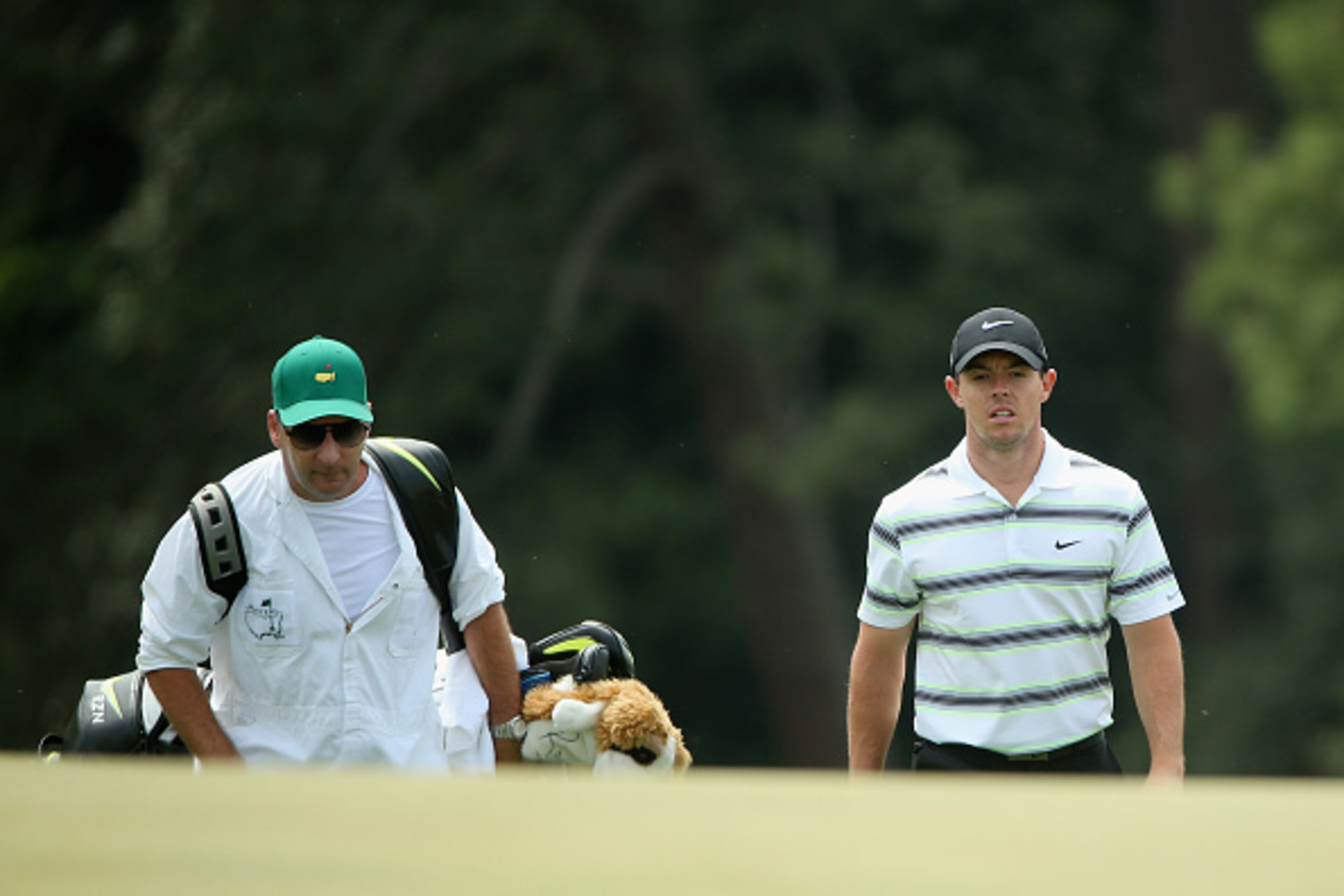 AUGUSTA, GA - APRIL 06: Rory McIlroy of Northern Ireland walks with caddie J.P. Fitzgerald during a practice round prior to the start of the 2015 Masters Tournament at Augusta National Golf Club on April 6, 2015 in Augusta, Georgia. (Photo by Andrew Red AUGUSTA, GA - APRIL 06: Rory McIlroy of Northern Ireland walks with caddie J.P. Fitzgerald during a practice round prior to the start of the 2015 Masters Tournament at Augusta National Golf Club on April 6, 2015 in Augusta, Georgia. (Photo by Andrew Red