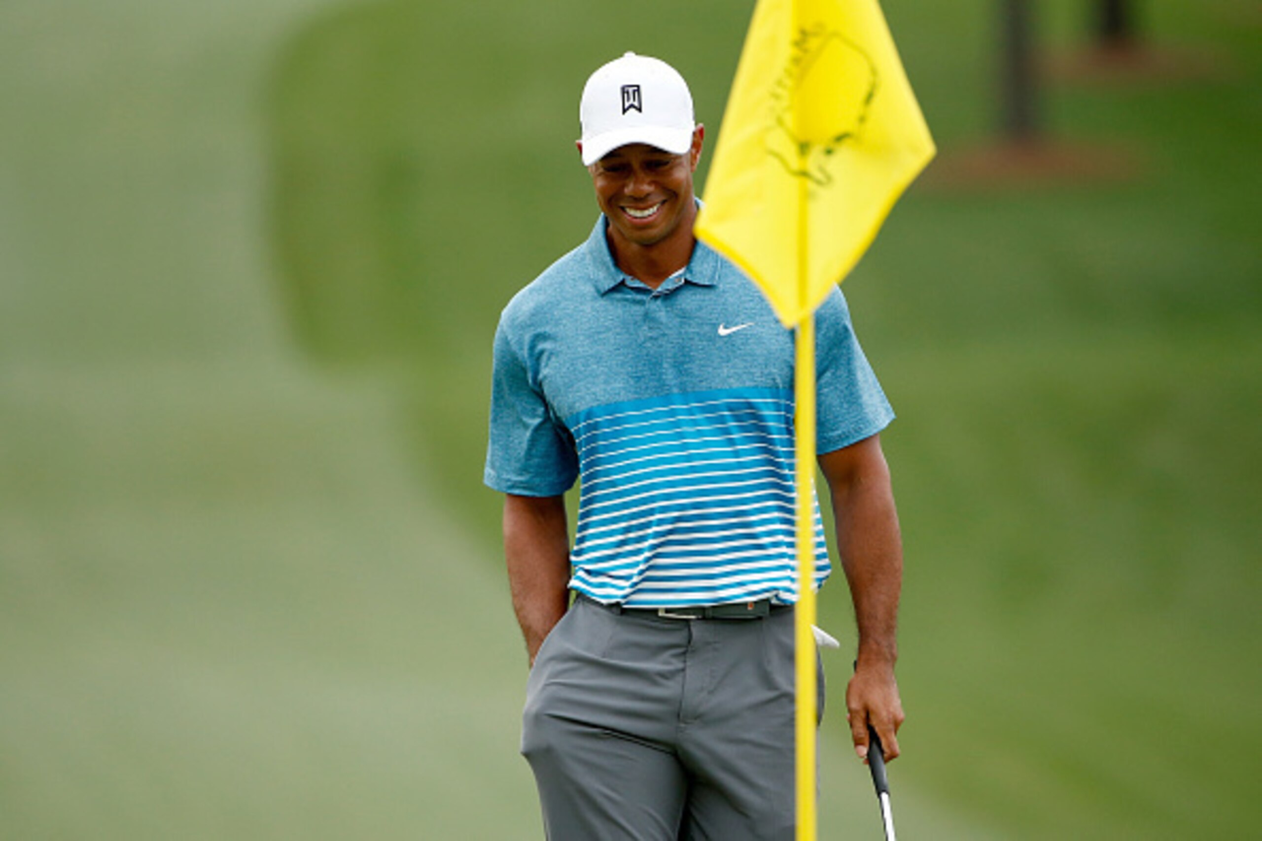 AUGUSTA, GA - APRIL 06:  Tiger Woods of the United States smiles as he walks onto a green during a practice round prior to the start of the 2015 Masters Tournament at Augusta National Golf Club on April 6, 2015 in Augusta, Georgia.  (Photo by Ezra Shaw/Ge