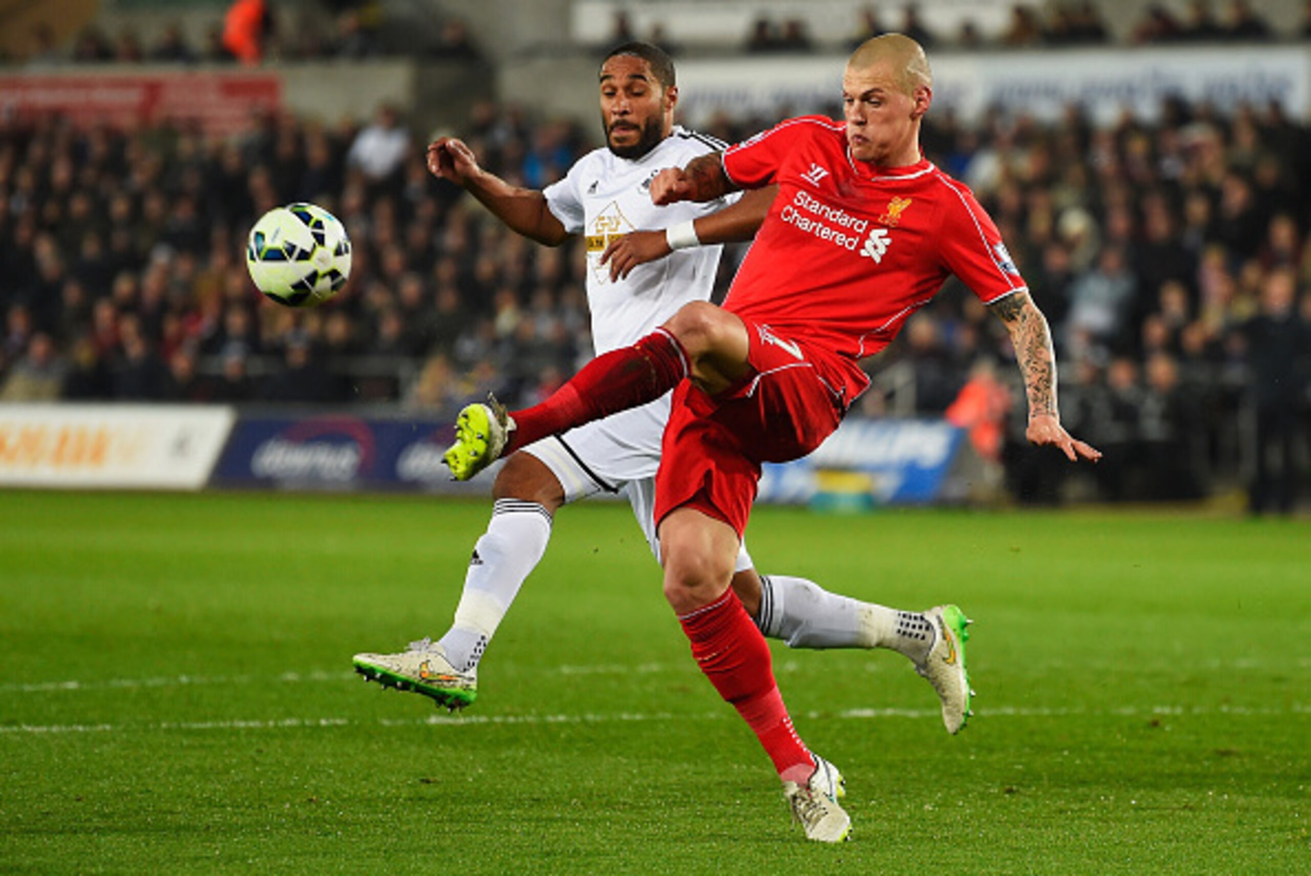 SWANSEA, WALES - MARCH 16: Martin Skrtel of Liverpool is closed down by Ashley Williams of Swansea City during the Barclays Premier League match between Swansea City and Liverpool at Liberty Stadium on March 16, 2015 in Swansea, Wales.  (Photo by Mike Hew