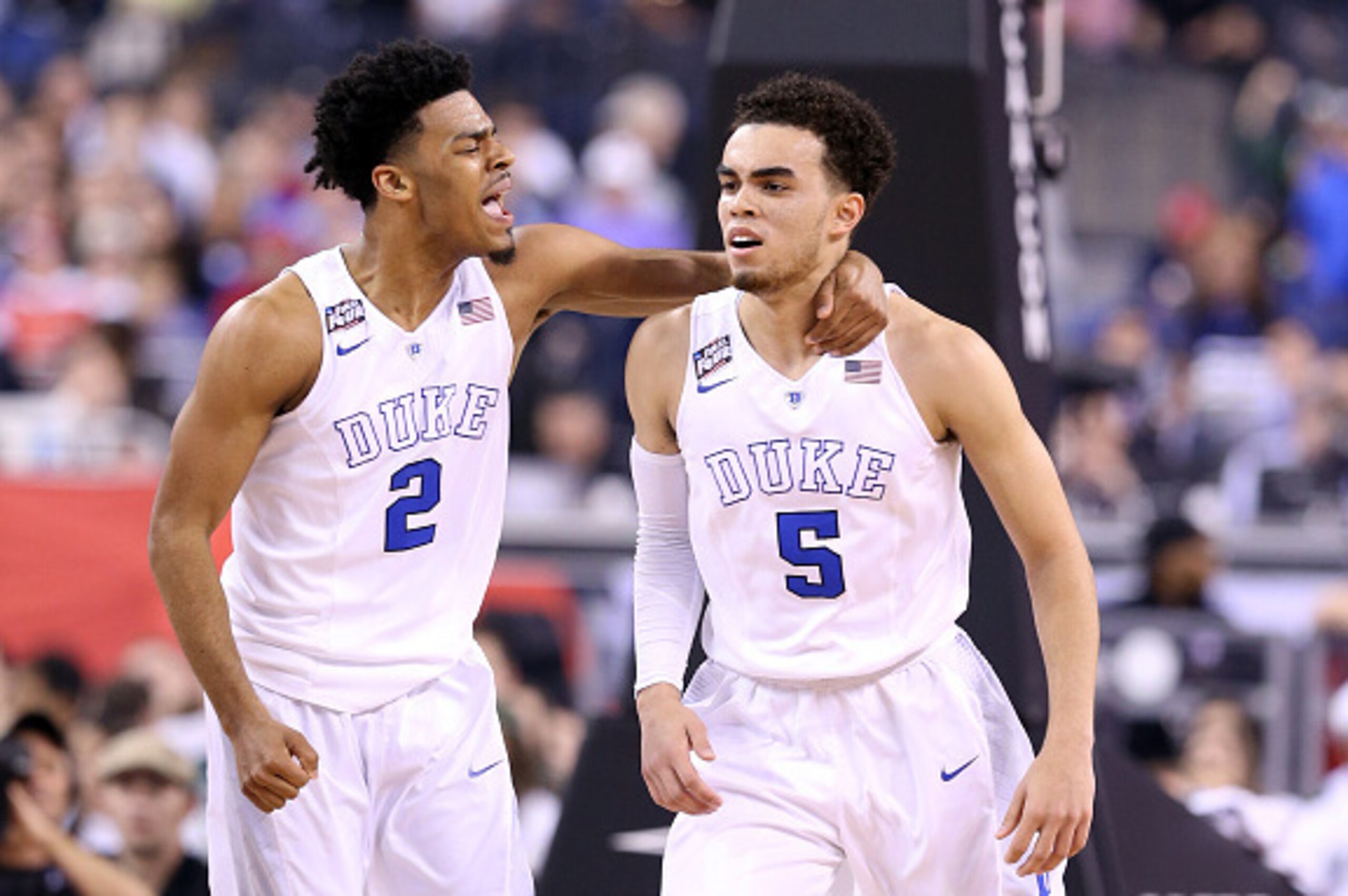INDIANAPOLIS, IN - APRIL 04:  Quinn Cook #2 and Tyus Jones #5 of the Duke Blue Devils celebrate after a play in the first half against the Michigan State Spartans during the NCAA Men's Final Four Semifinal at Lucas Oil Stadium on April 4, 2015 in Indianap