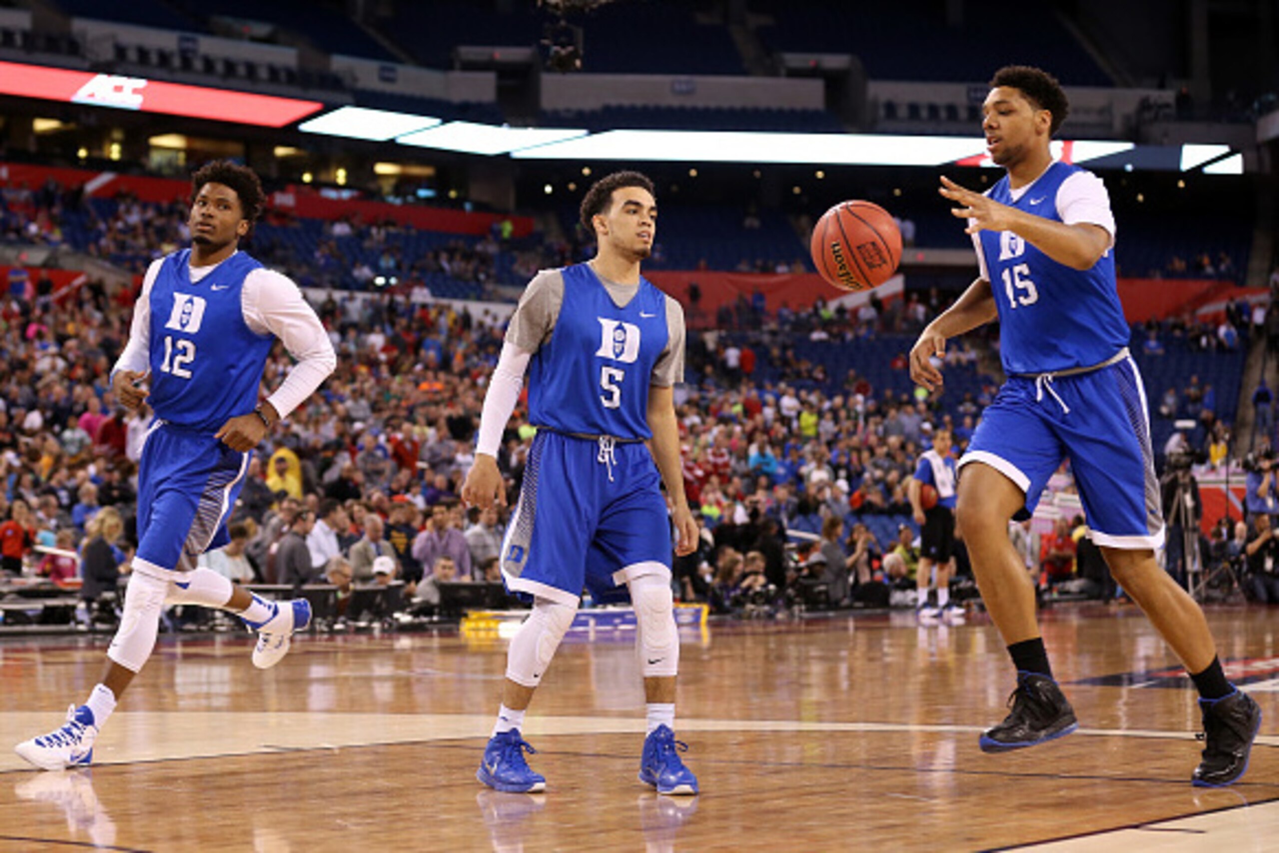 INDIANAPOLIS, IN - APRIL 03: Justise Winslow #12, Tyus Jones #5 and Jahlil Okafor #15 of the Duke Blue Devils handle the ball during practice for the NCAA Men's Final Four at Lucas Oil Stadium on April 3, 2015 in Indianapolis, Indiana.  (Photo by Streeter