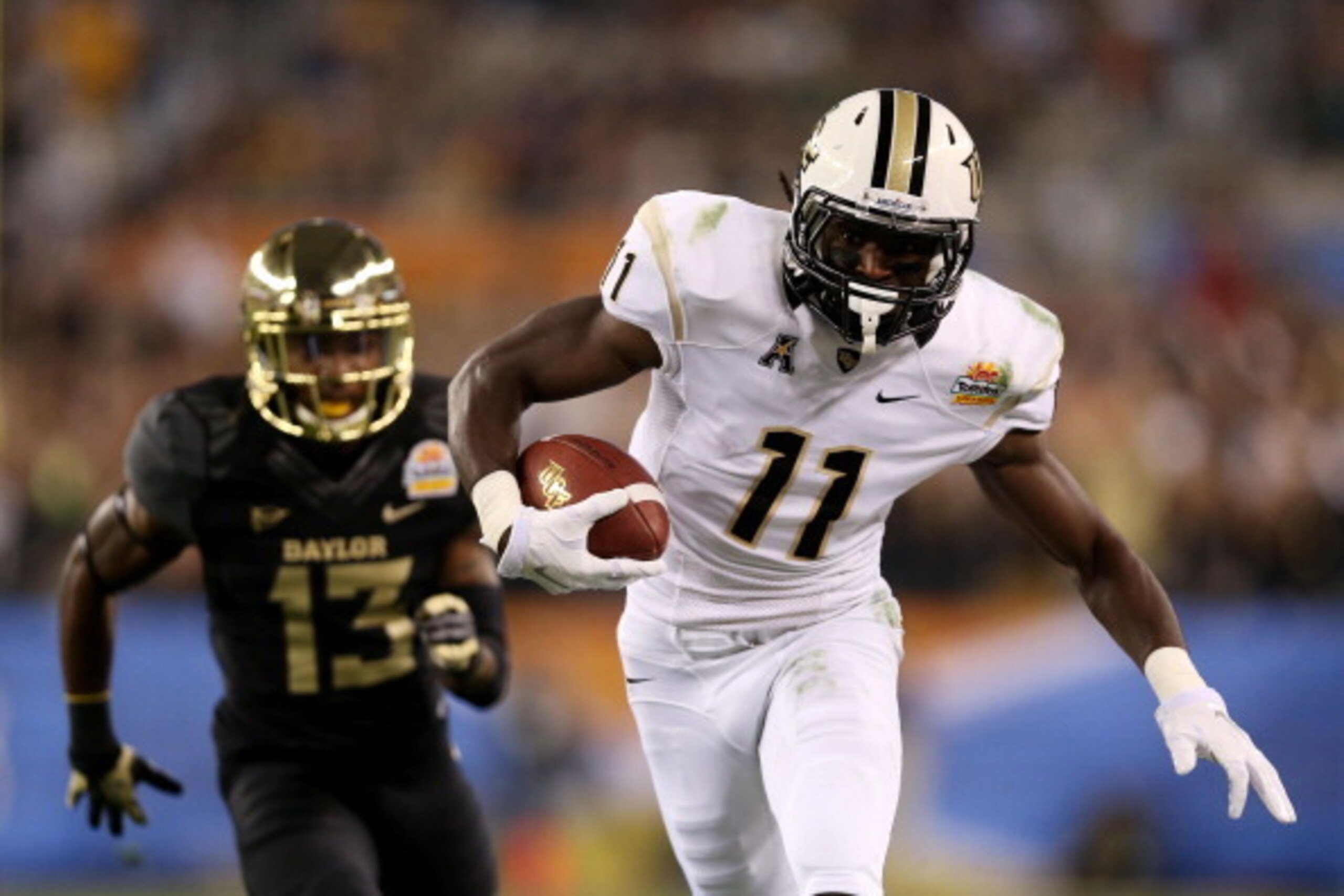 GLENDALE, AZ - JANUARY 01:  Breshad Perriman #11 of the UCF Knights completes a pass for 44 yards in the first quarter against the defense of Terrell Burt #13 of the Baylor Bears during the Tostitos Fiesta Bowl at University of Phoenix Stadium on January 