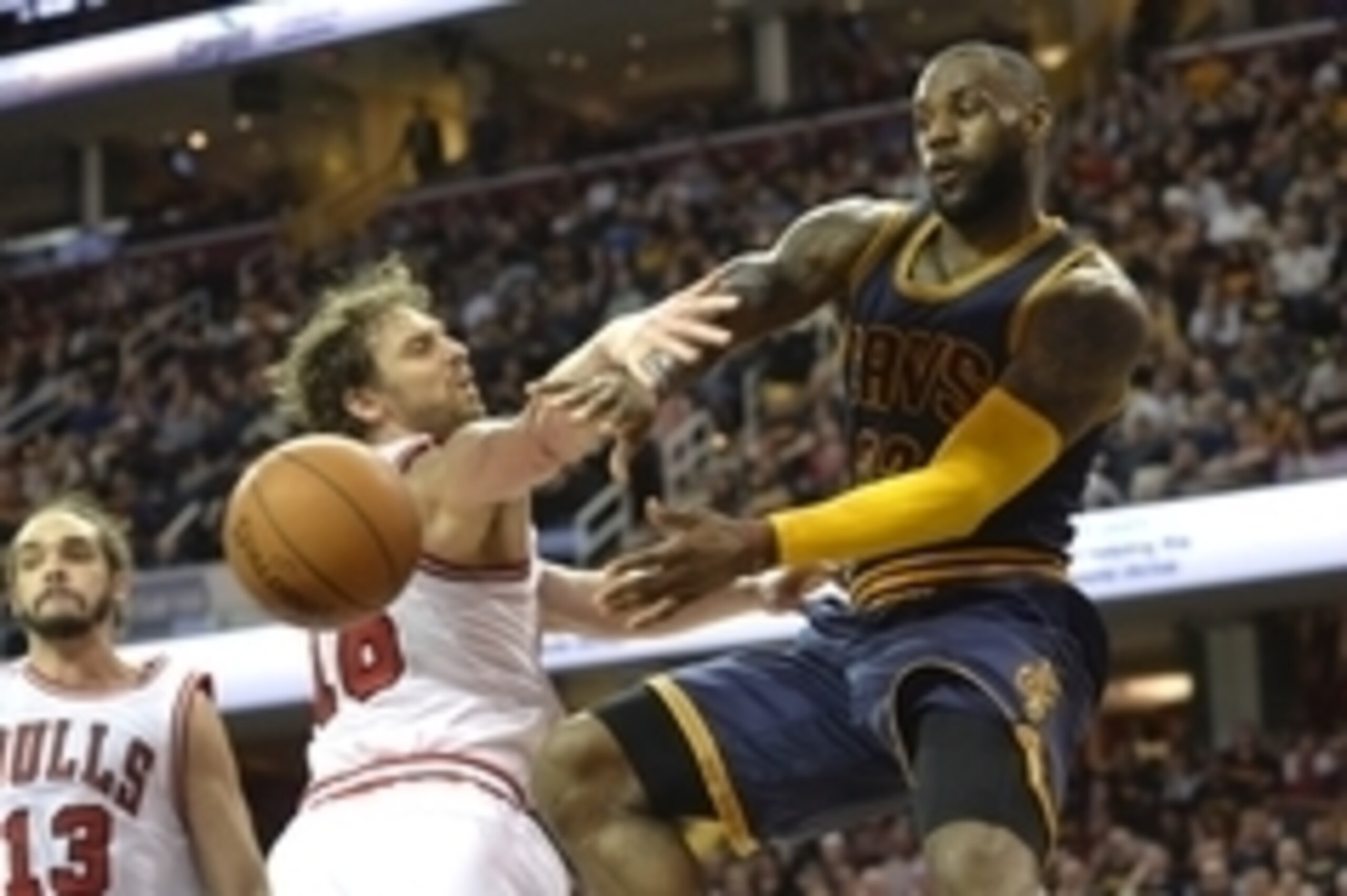 Apr 5, 2015; Cleveland, OH, USA; Cleveland Cavaliers forward LeBron James (23) passes around Chicago Bulls forward Pau Gasol (16) and center Joakim Noah (13) in the third quarter at Quicken Loans Arena. Mandatory Credit: David Richard-USA TODAY Sports