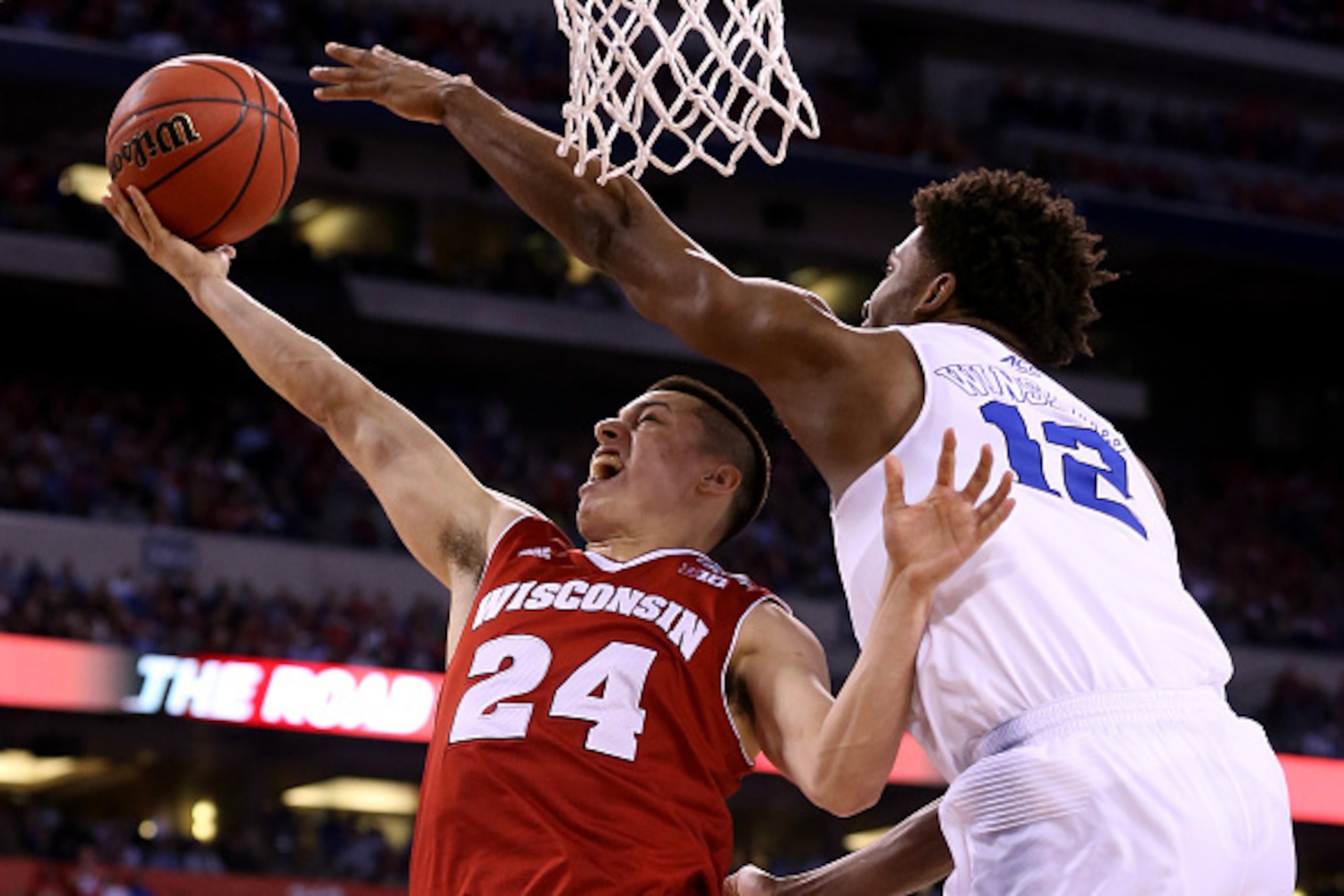 INDIANAPOLIS, IN - APRIL 06: Bronson Koenig #24 of the Wisconsin Badgers drives to the basket against Justise Winslow #12 of the Duke Blue Devils in the second half during the NCAA Men's Final Four National Championship at Lucas Oil Stadium on April 6, 20