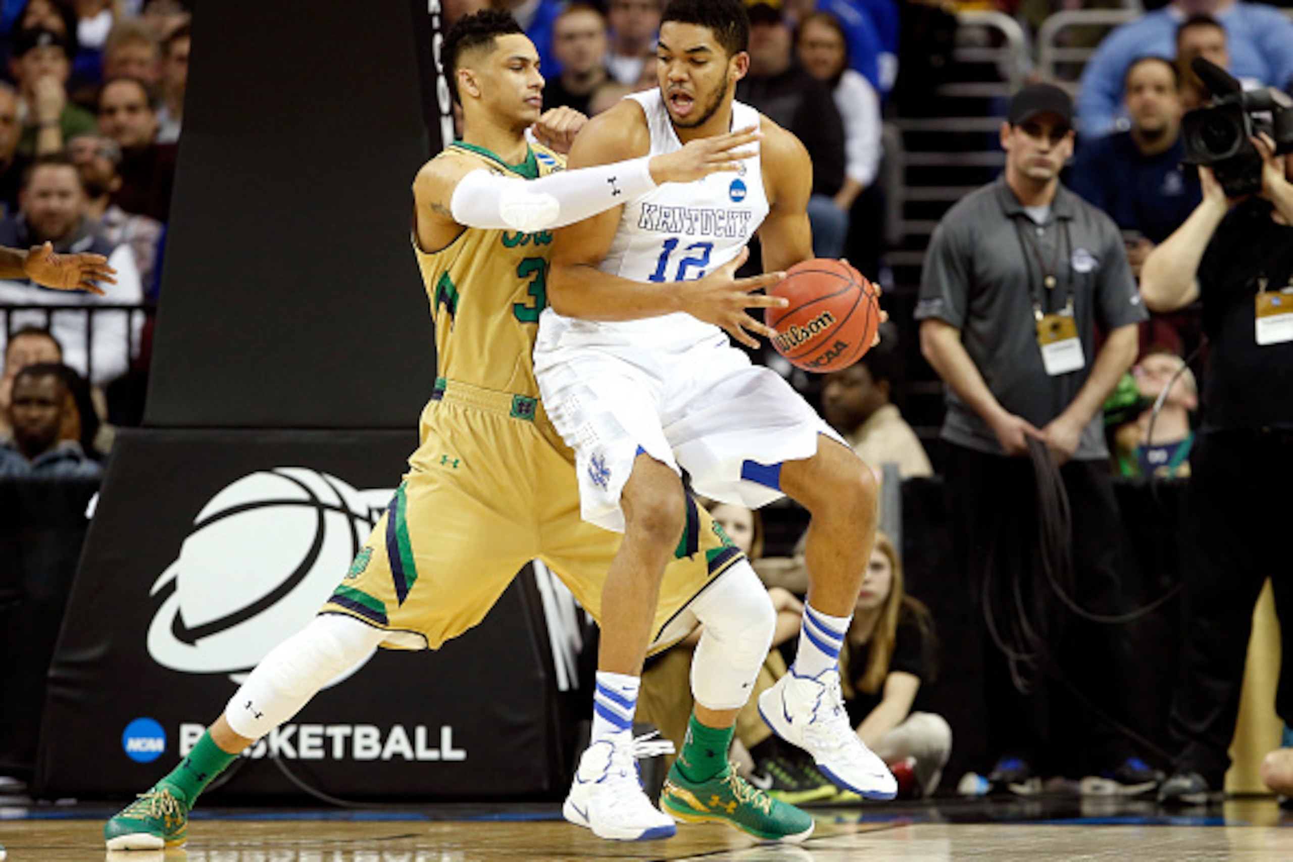 CLEVELAND, OH - MARCH 28: Zach Auguste #30 of the Notre Dame Fighting Irish defends Karl-Anthony Towns #12 of the Kentucky Wildcats in the first half during the Midwest Regional Final of the 2015 NCAA Men's Basketball tournament at Quicken Loans Arena on 