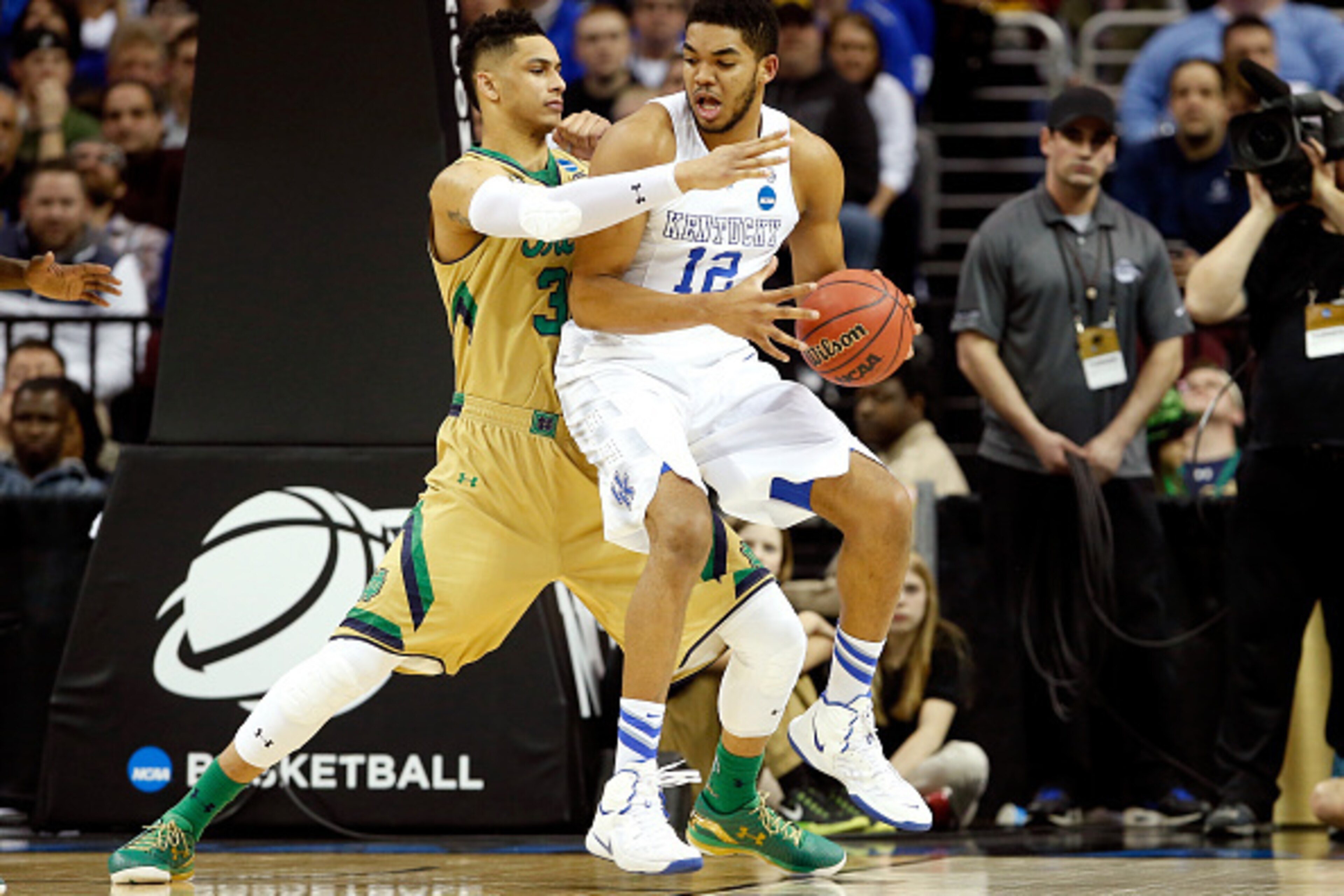 CLEVELAND, OH - MARCH 28: Zach Auguste #30 of the Notre Dame Fighting Irish defends Karl-Anthony Towns #12 of the Kentucky Wildcats in the first half during the Midwest Regional Final of the 2015 NCAA Men's Basketball tournament at Quicken Loans Arena on 