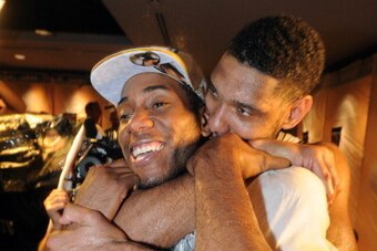 SAN ANTONIO, TX - JUNE 15: Tim Duncan #21 and Kawhi Leonard #2 of the San Antonio Spurs celebrates after winning the NBA Championship against the Miami Heat during Game Five of the 2014 NBA Finals between the Miami Heat and San Antonio Spurs at AT&T Cente